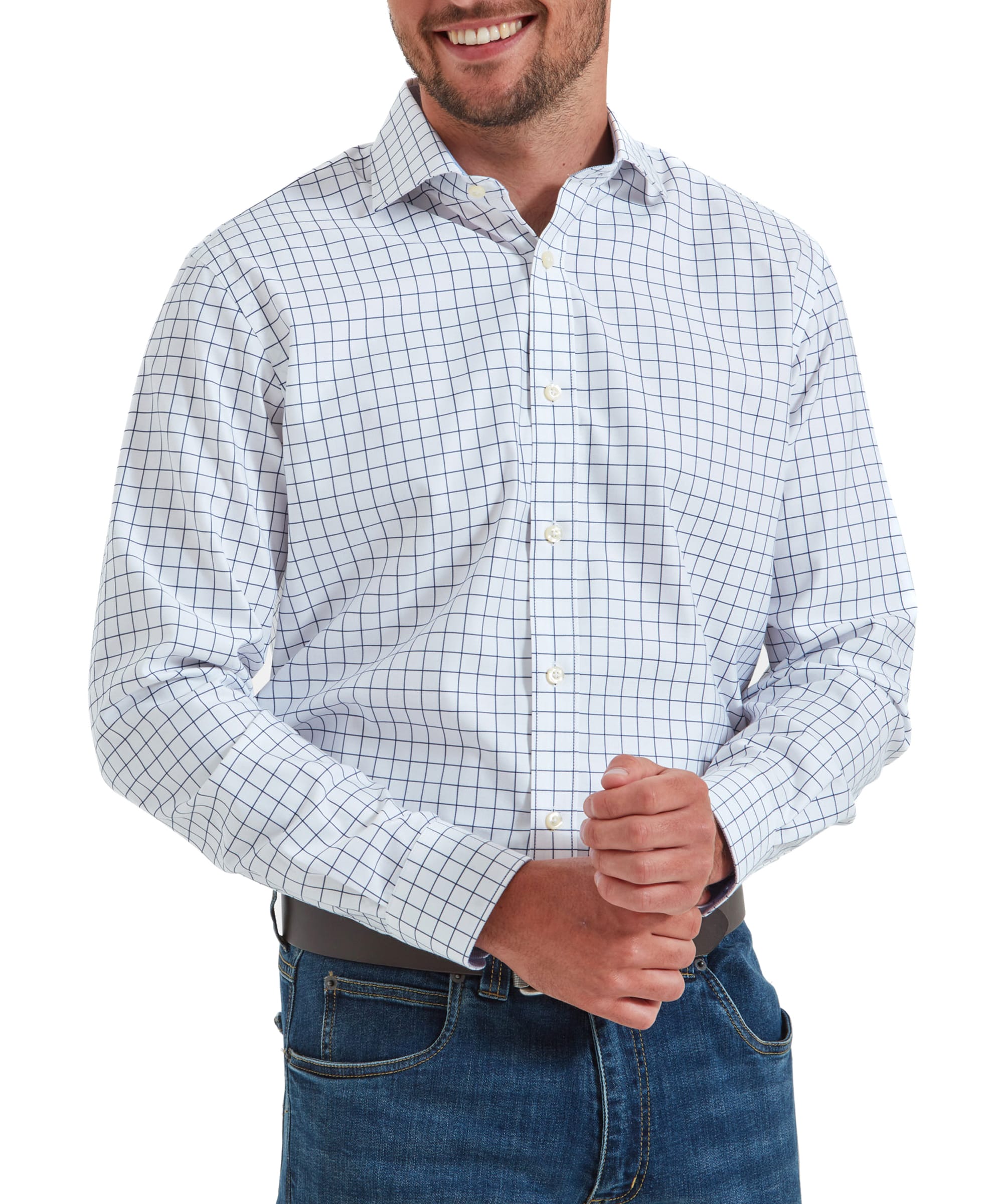 Man wearing the Schöffel Greenwich Tailored Shirt for Men in Navy, smiling with his hands clasped in front of him.