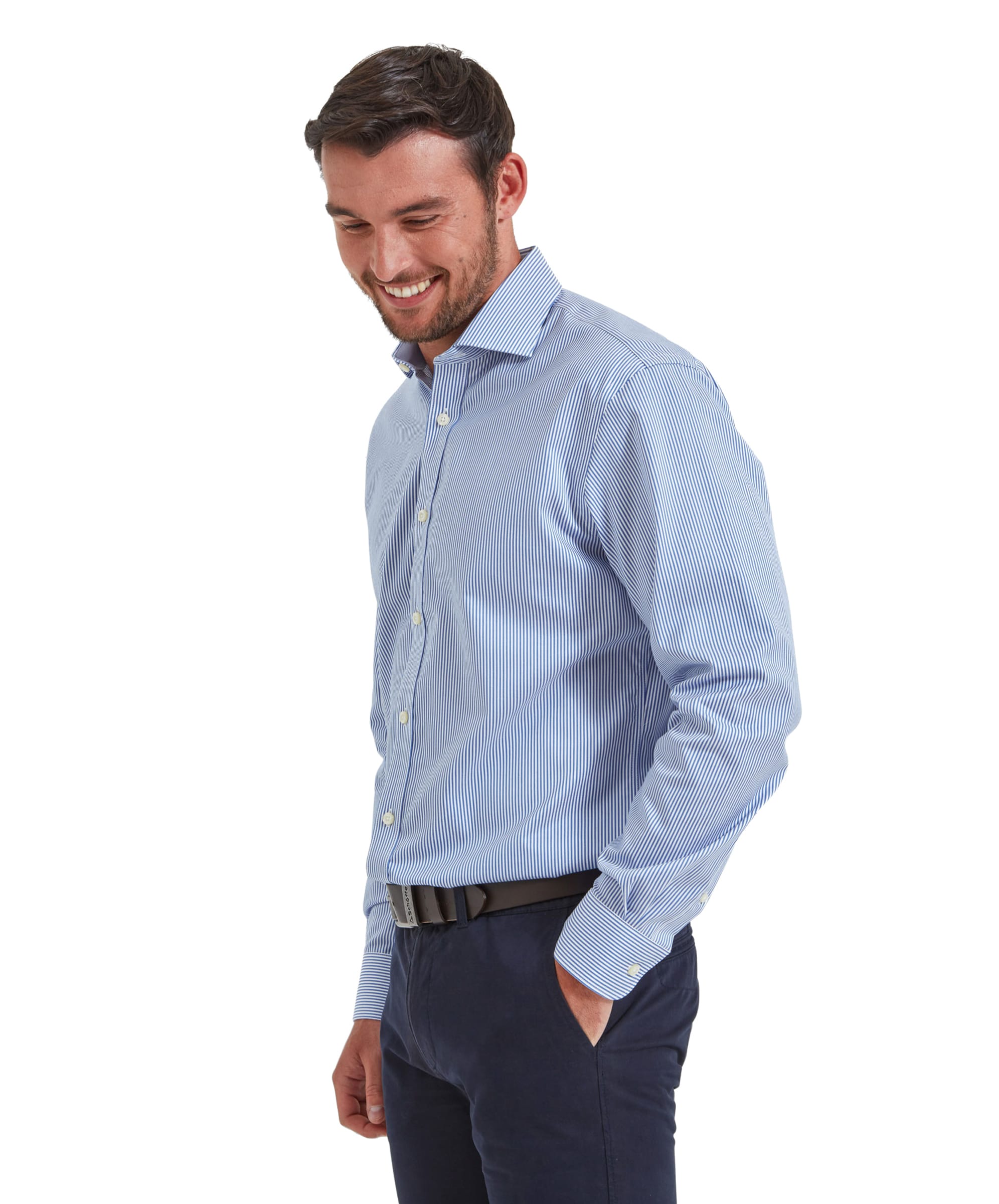 A man wearing the Schöffel Greenwich Tailored Shirt for Men in Navy Stripe, smiling and looking down, hands clasped together. The shirt features a sleek, tailored fit with a classic collar and long sleeves.