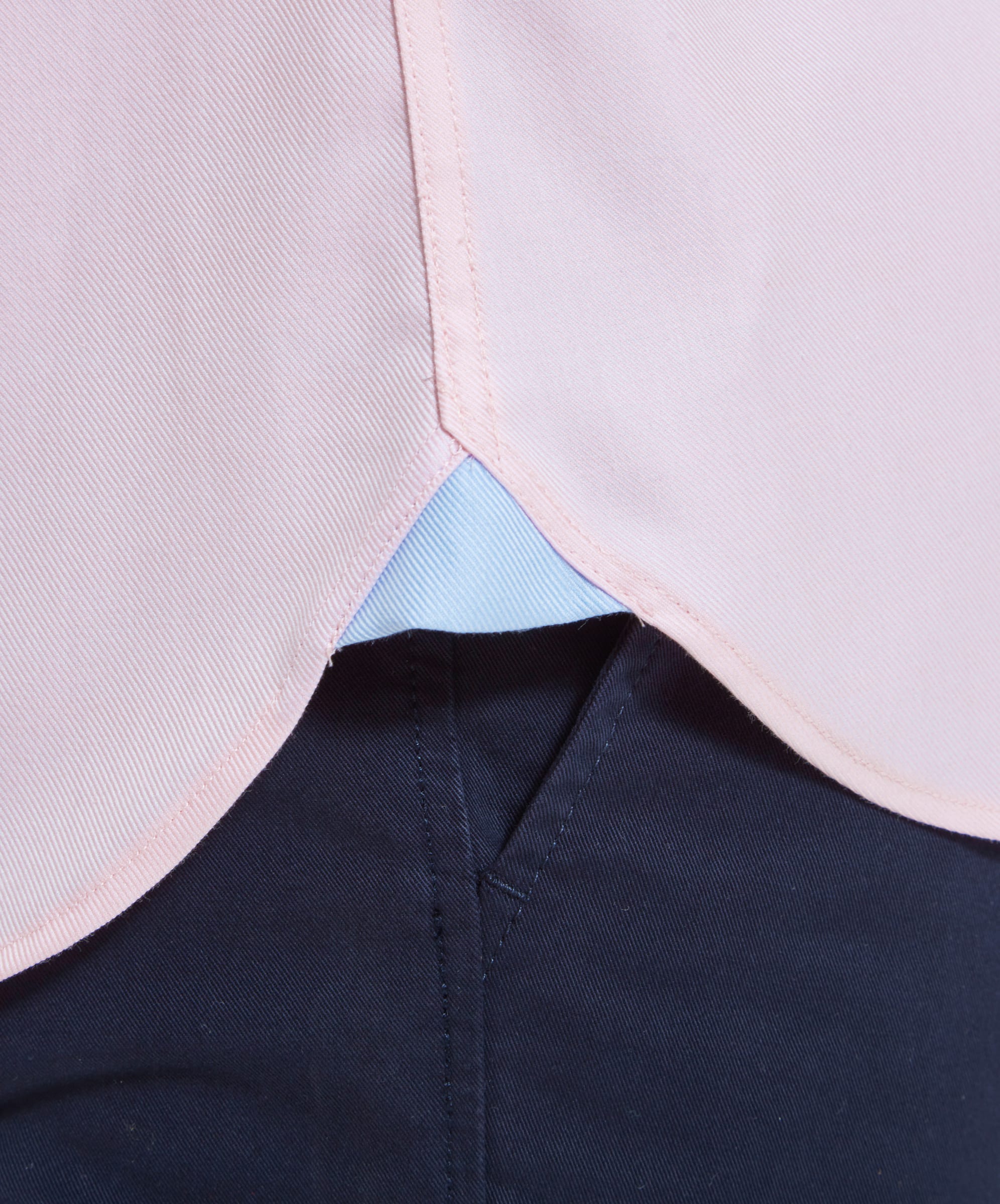 A close-up of the gusset hem of the Schöffel Greenwich Tailored Shirt for Men in Pink, highlighting the craftsmanship and attention to detail.