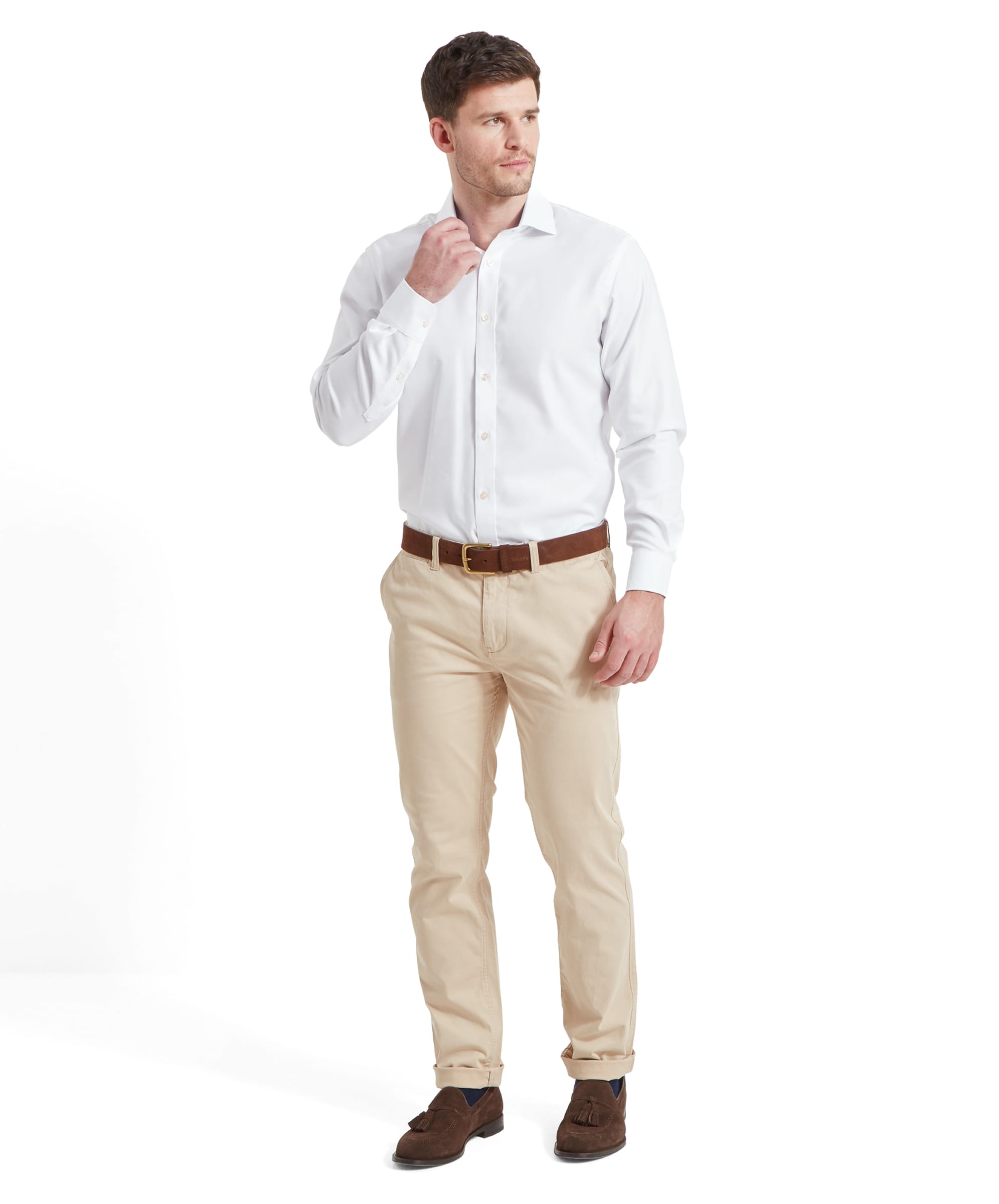 Full-body view of model in Schöffel Greenwich Tailored Shirt for Men in White, adjusting collar.