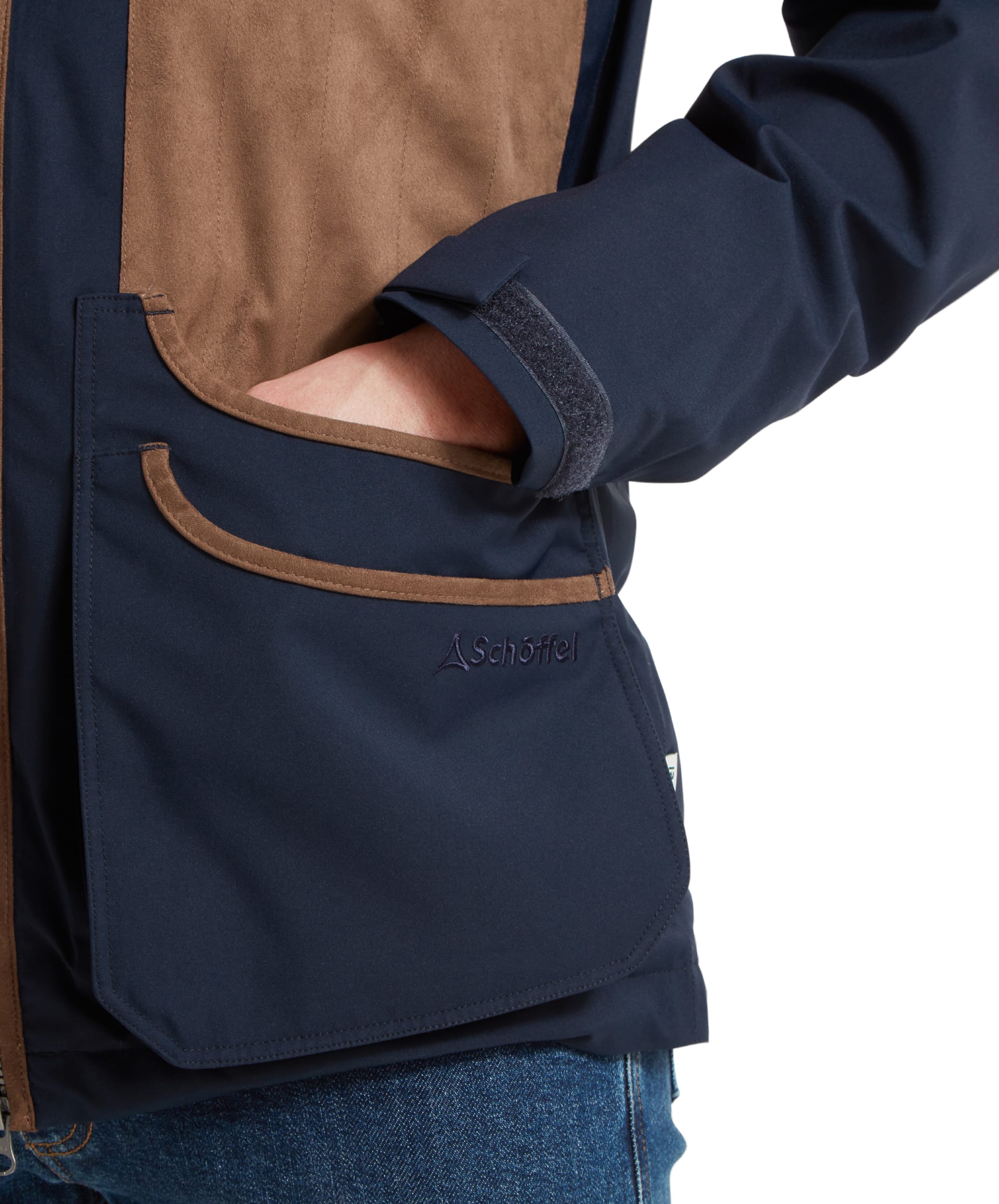 Close-up of the Schöffel Grimsthorpe Clay Shooting Jacket for Men in Blue's pocket, highlighting the Schöffel branding.