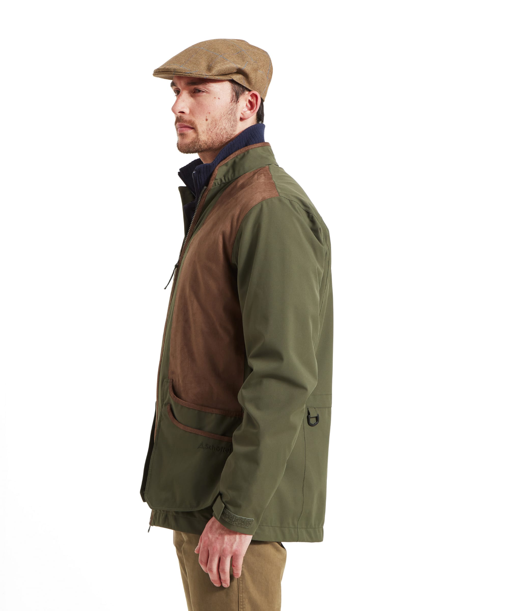 Side view of a man in the Schöffel Grimsthorpe Clay Shooting Jacket in Green, showing the jacket's fit and side pockets.