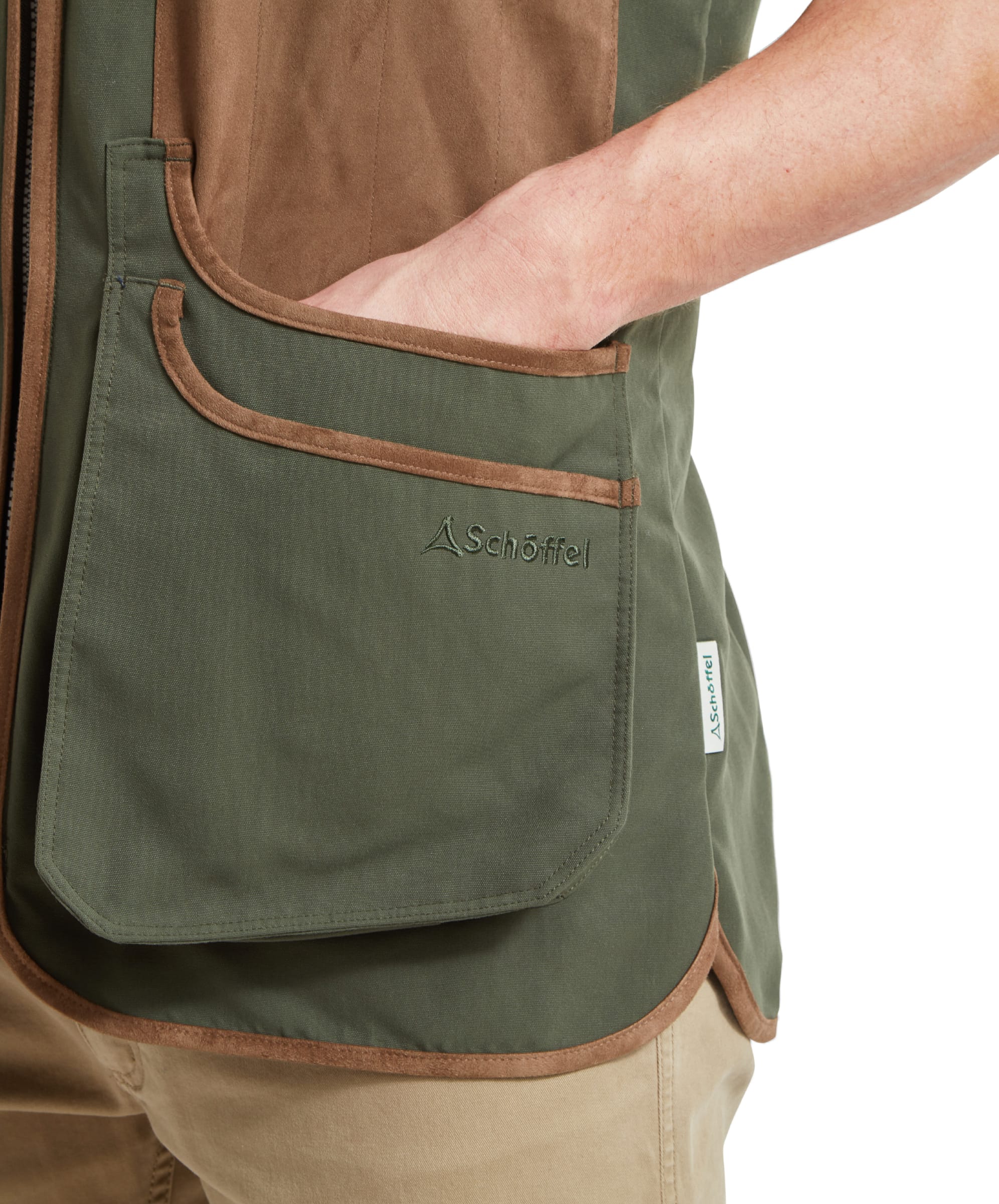 Close-up of the pocket of the Schöffel Grimsthorpe Clay Shooting Vest for Men in Green, highlighting the logo and suede trim design.