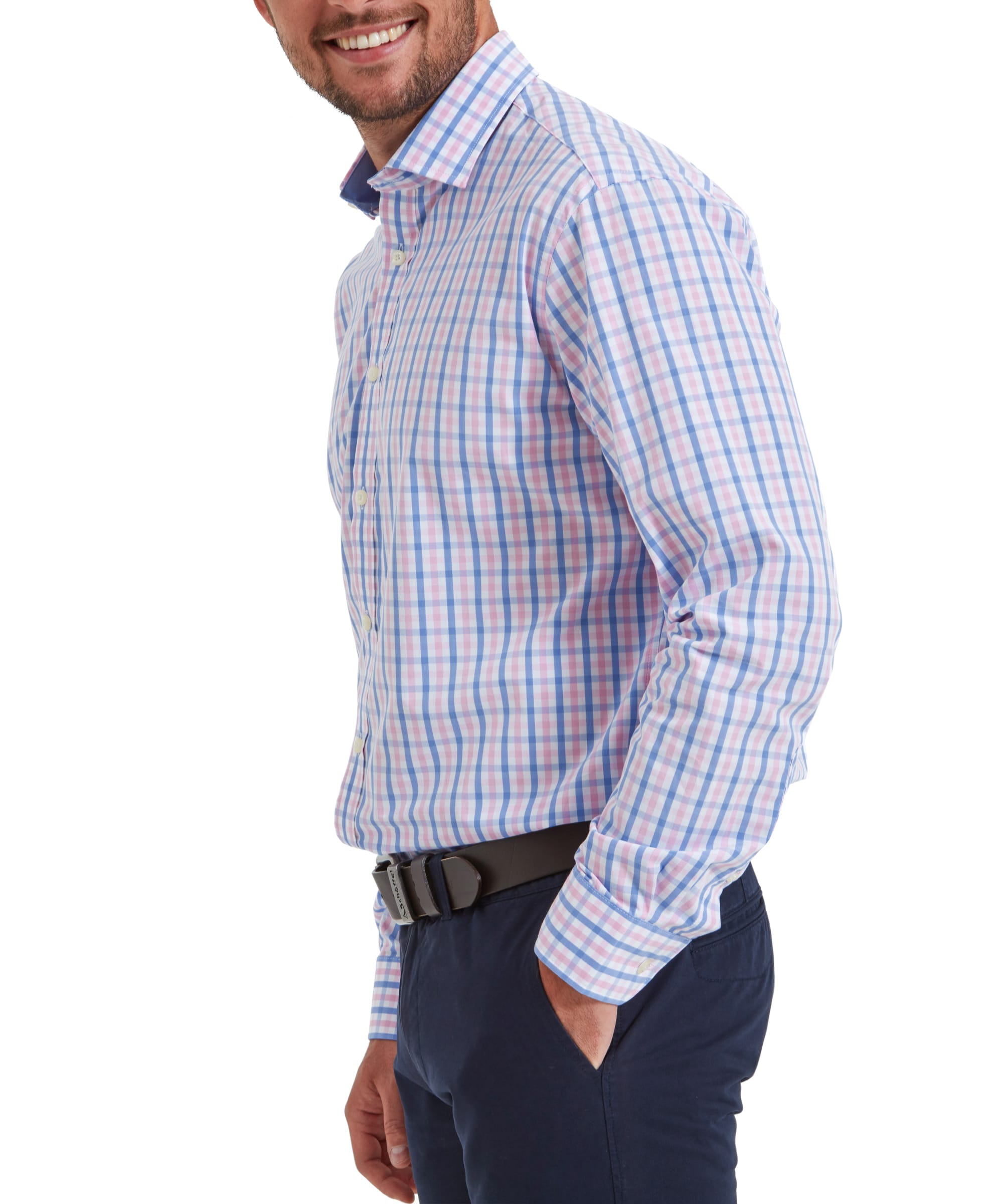 A side profile of the Schöffel Hebden Tailored Shirt for Men in Blue and Pink as the model has his right hand in his nay trousers. This highlights the shirts fit and light blue and pale pink checkered pattern.