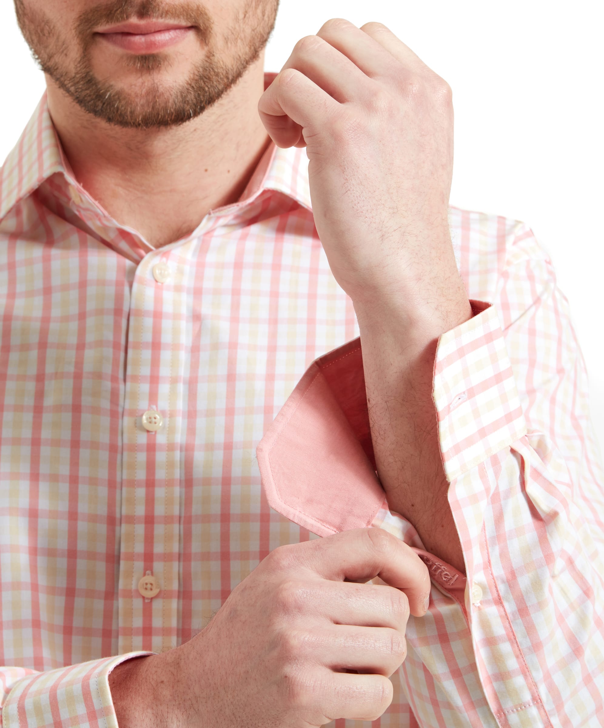 Close-up of the cuff of the Schöffel Hebden Tailored Shirt for Men in Pink Check highlighting the pale pink interior of the cuff as the man adjusts the buttons.