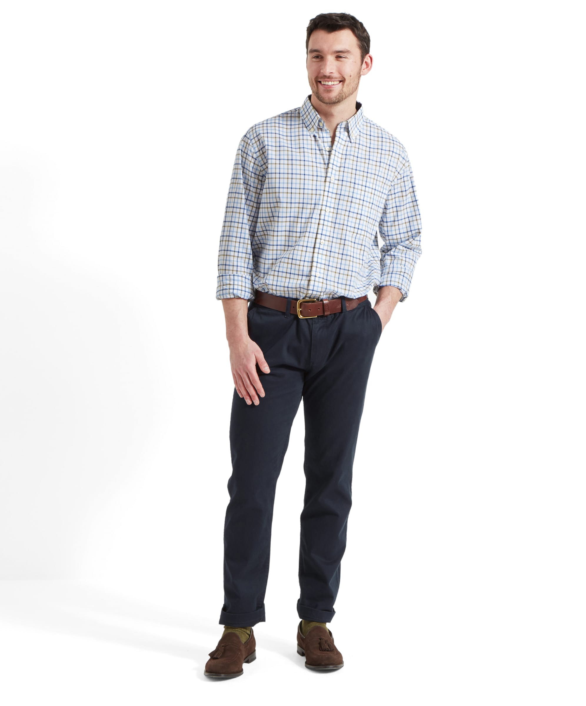 Full body view of the man wearing the Schöffel Holkham Classic Shirt for Men in Navy, he's smiling to his left and wears the shirt with blue trousers and dark brown suede loafers.