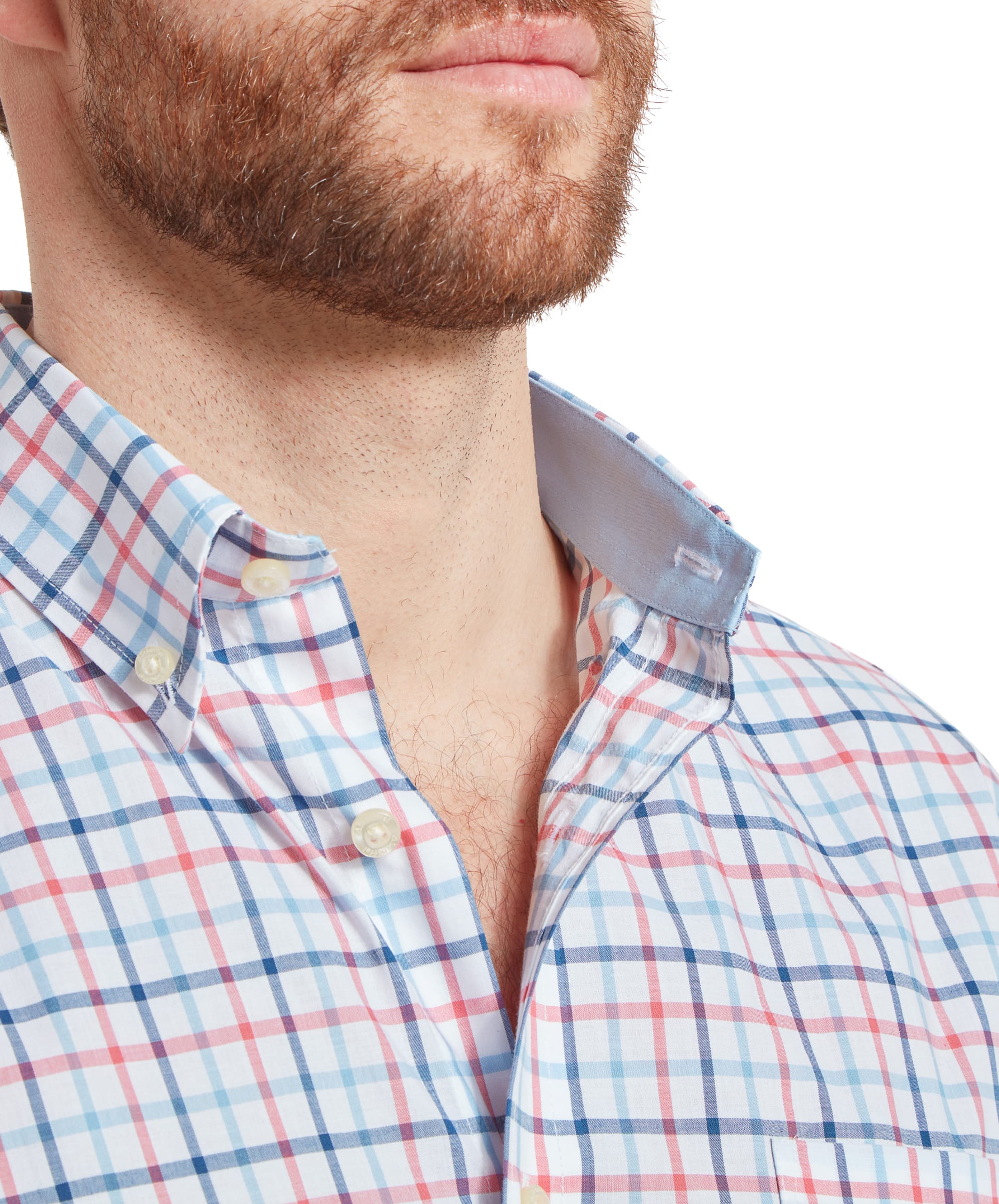 Close-up of the collar on the Schöffel Holkham Classic Shirt for Men in Navy and Red, highlighting the light blue collar lining as the shirt is worn slightly unbuttoned. The collar has a button-down finish.