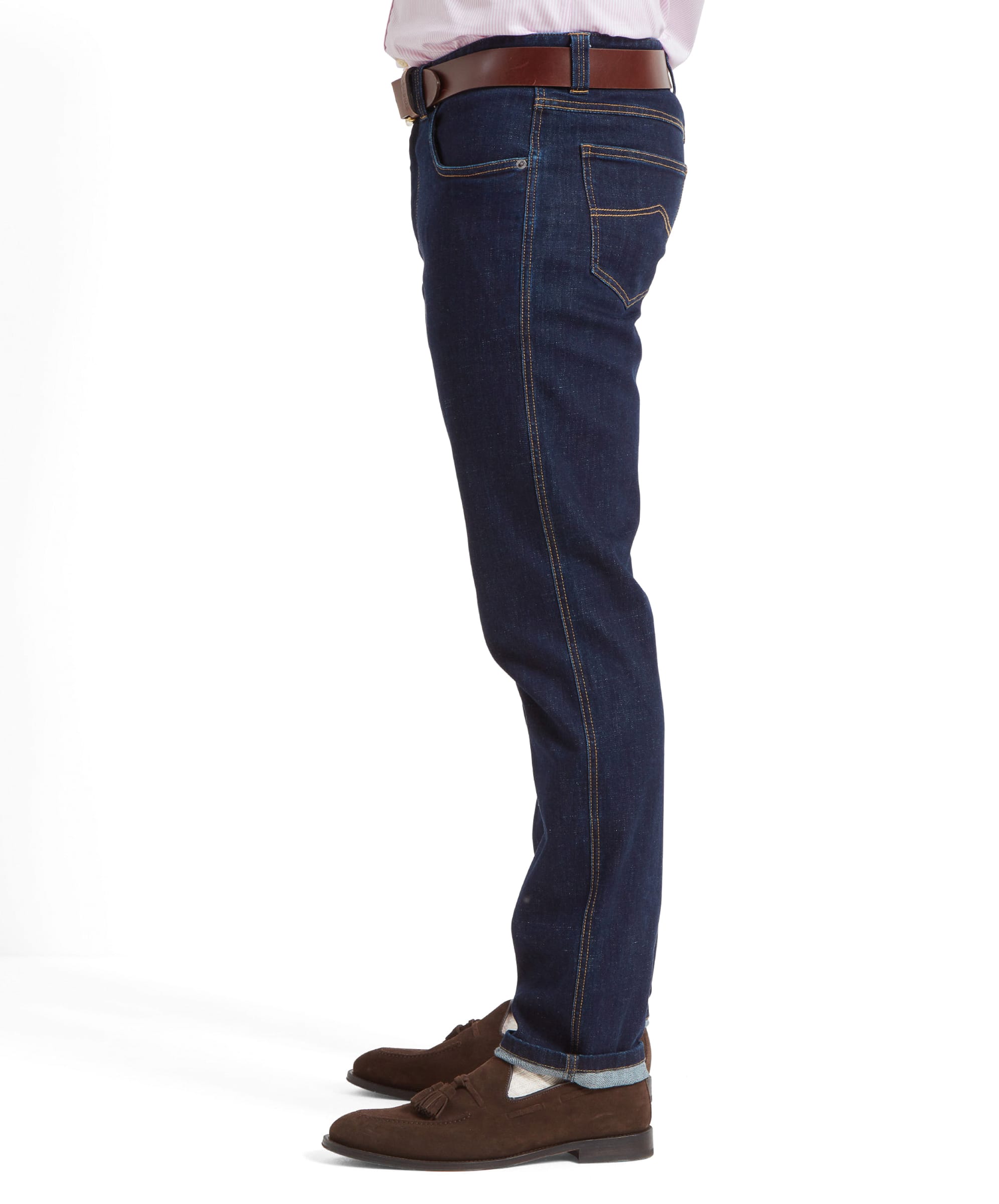 Side view of the Schöffel James Jean for Men in Navy highlighting the golden top stitching across key areas on the jeans. The outfit is completed with a brown leather belt and brown suede loafers.