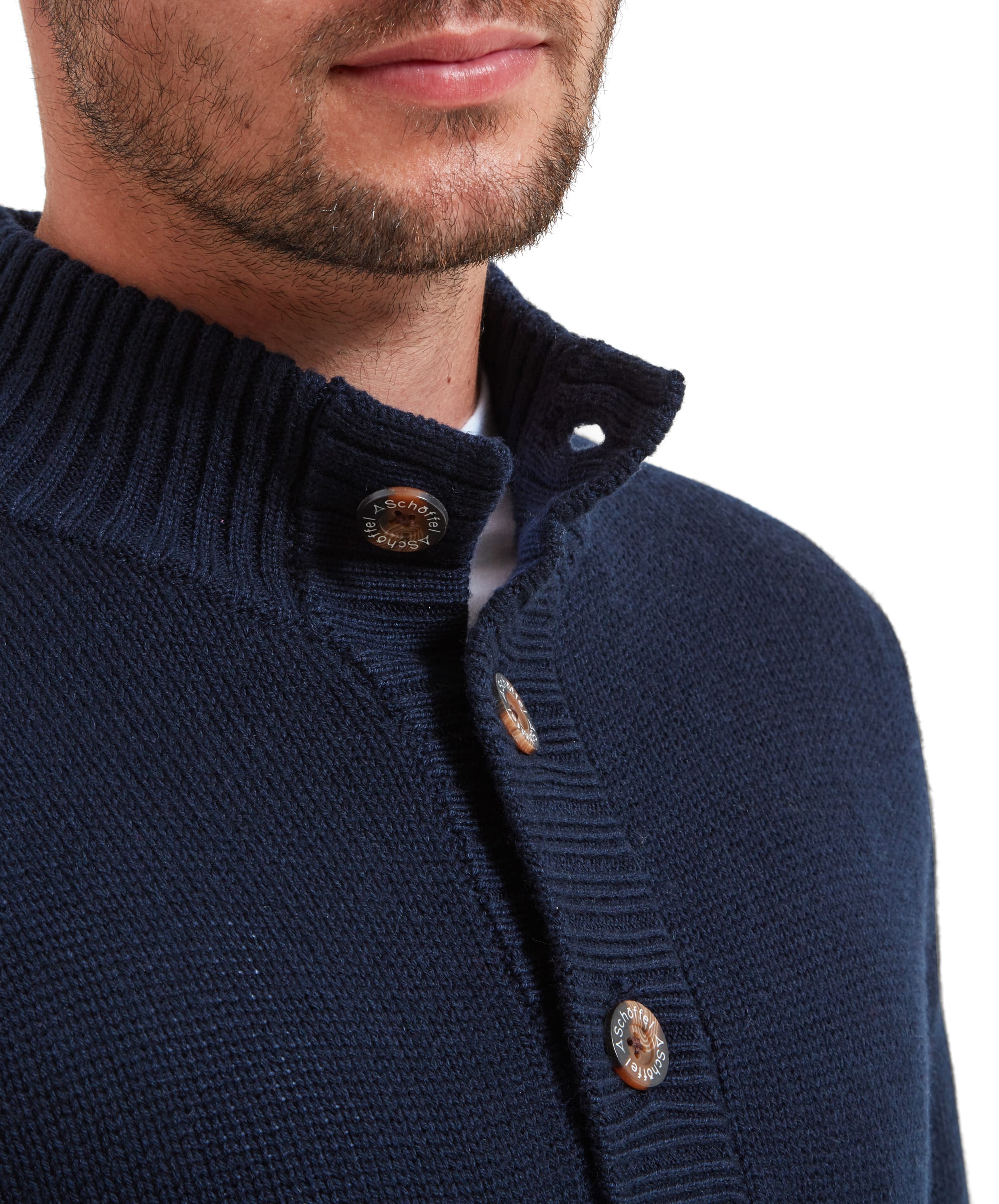 Close-up of the buttons collar section of the Schöffel Kenmore Lambswool Mix Jumper for Men in Navy. The sweater is worn with the top button open and then other 2 fastened, the buttons feature branding.