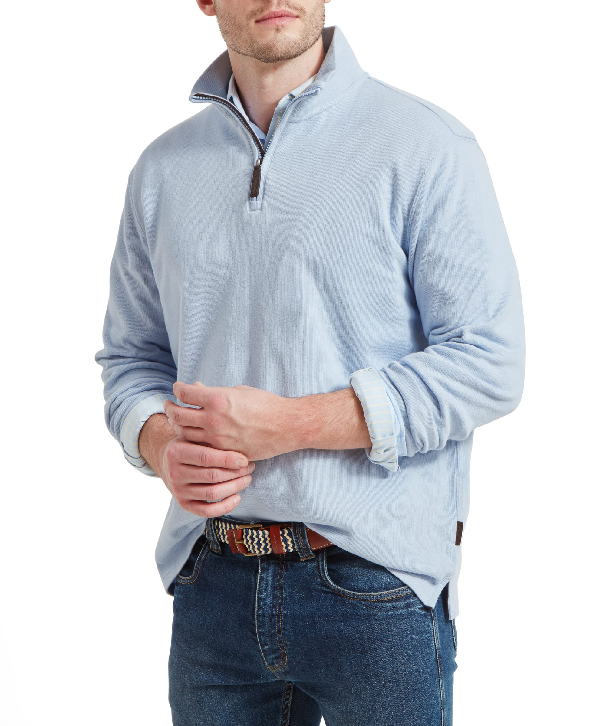 A man wears the Schöffel Kingsbridge Cotton French Rib 1/4 Zip for Men in Light Blue with a blue shirt and denim jeans.