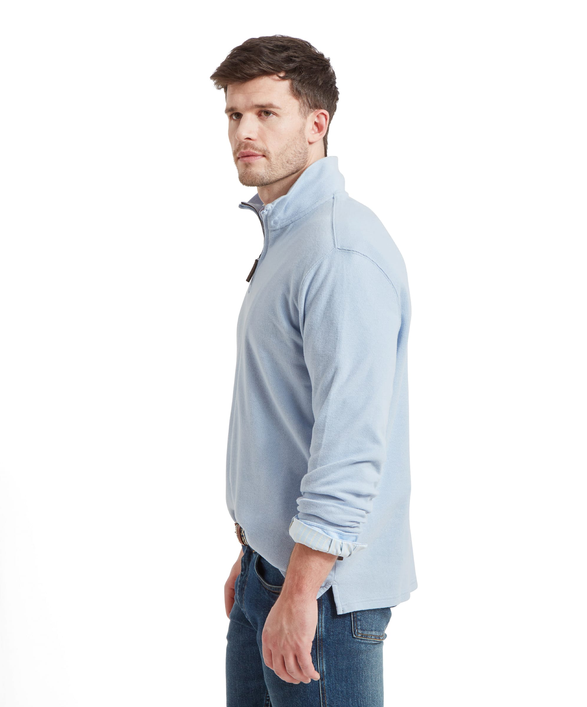 Side view of the Schöffel Kingsbridge Cotton French Rib 1/4 Zip for Men in Light Blue, the man wears it with the sleeves rolled up his forearms.