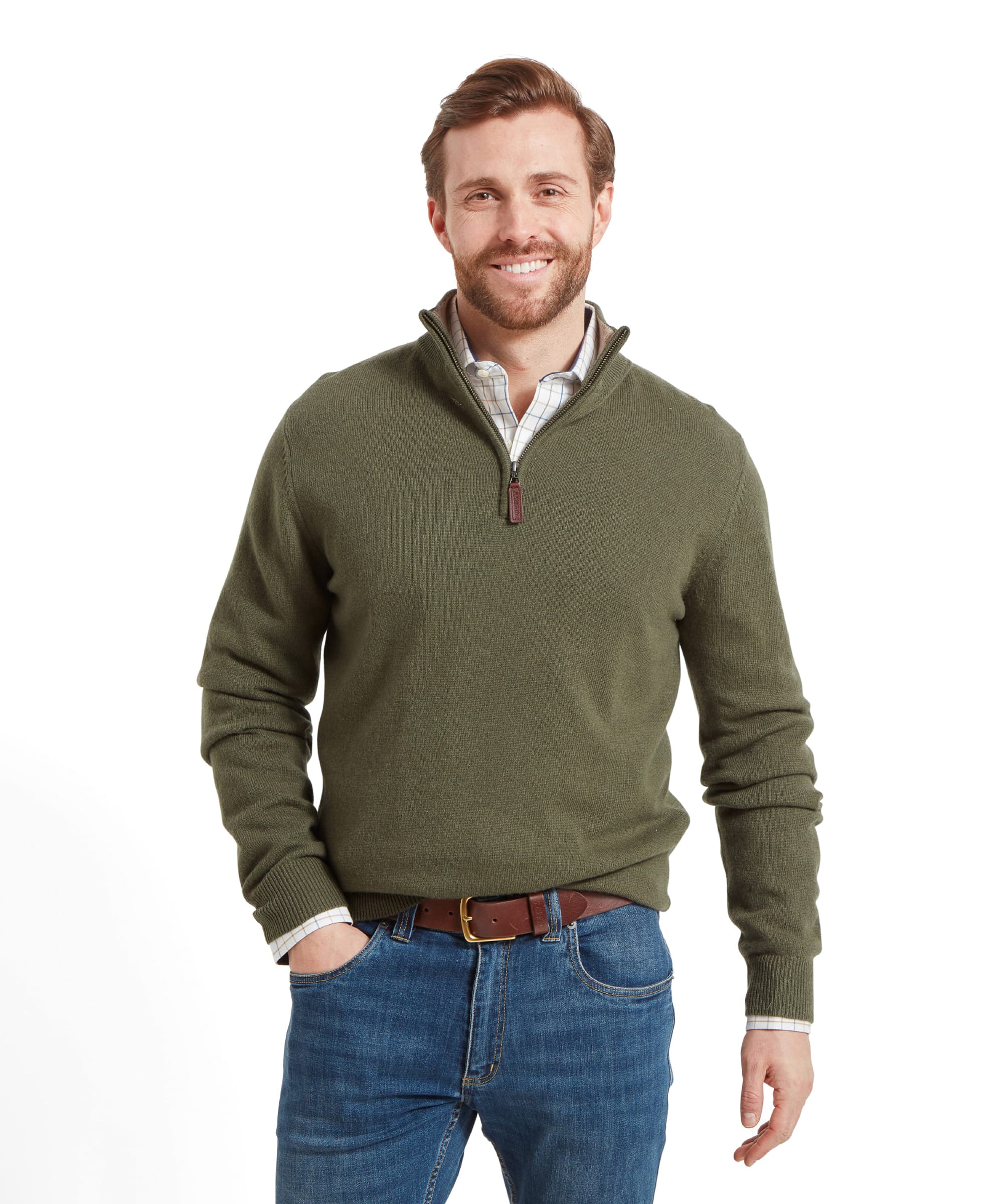 A man wears the Schöffel Lambswool 1/4 Zip for Men in Green with the front tucked into the top of his jeans. He has his left hand in his jeans pocket and is looking at the camera.