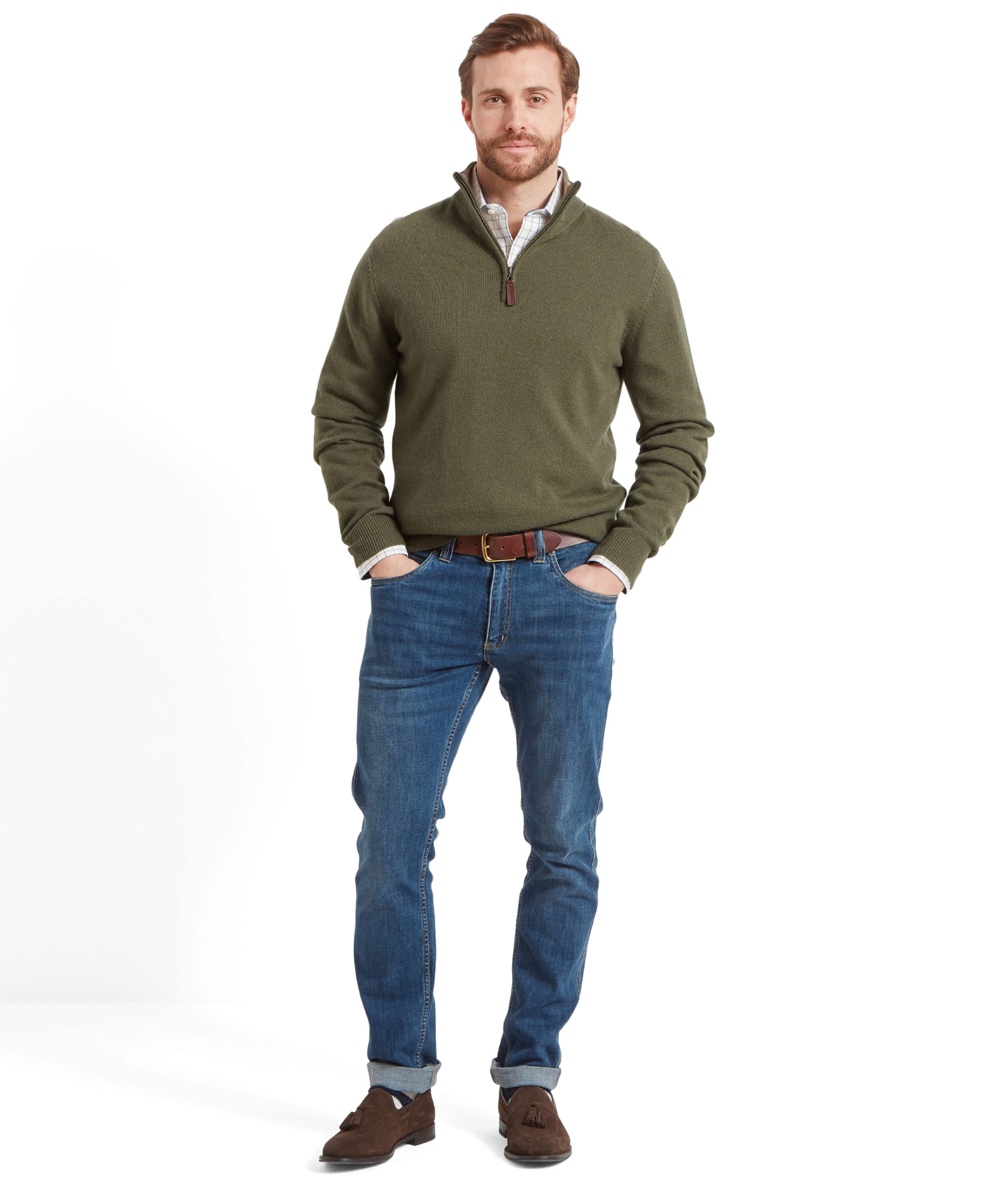 Full view of the same man wearing the Schöffel Lambswool 1/4 Zip for Men in Green partnered with denim jeans, tan leather belt and a dark brown loafers. Under the sweater you can see a checkered shirt.