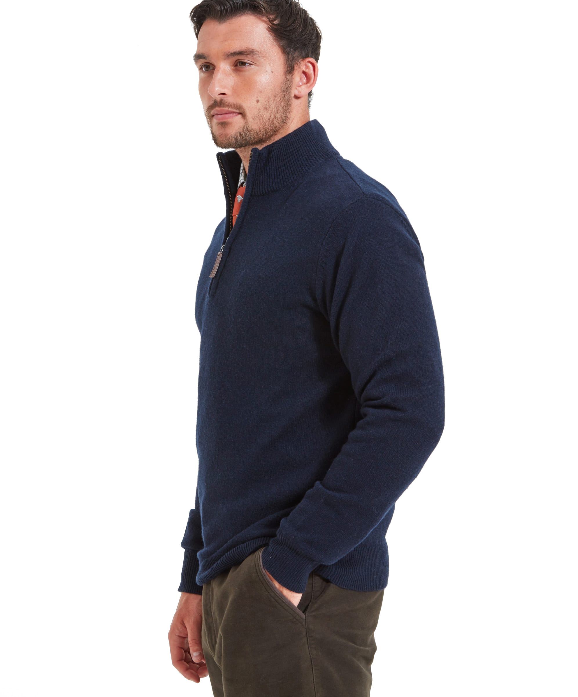 A side view of the Schöffel Lambswool 1/4 Zip for Men in Navy and the model wears his right hand in his trouser pocket.