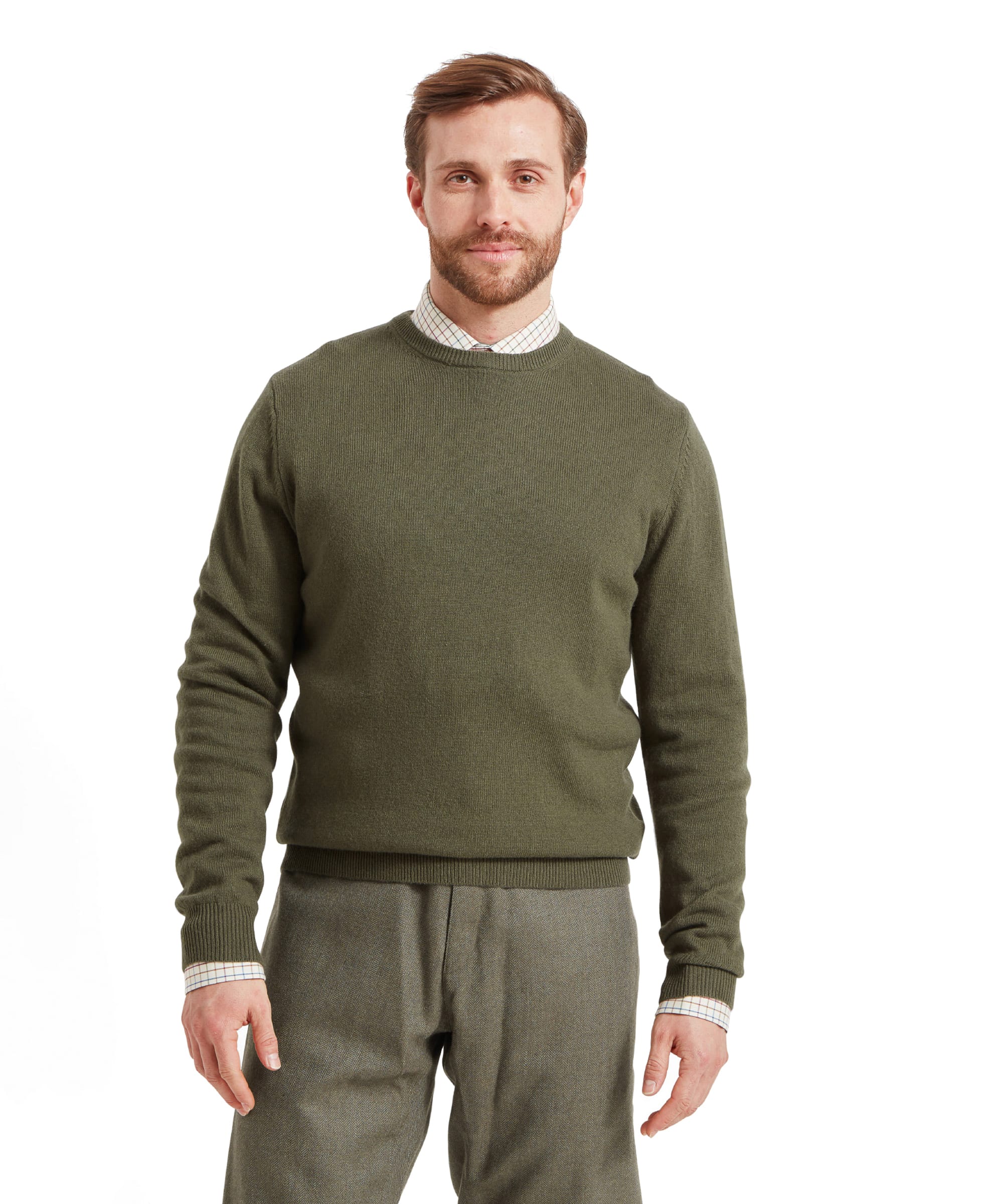 A man wears a Schöffel Lambswool 1/4 Zip for Men in Green with tweed trousers and a check shirt.