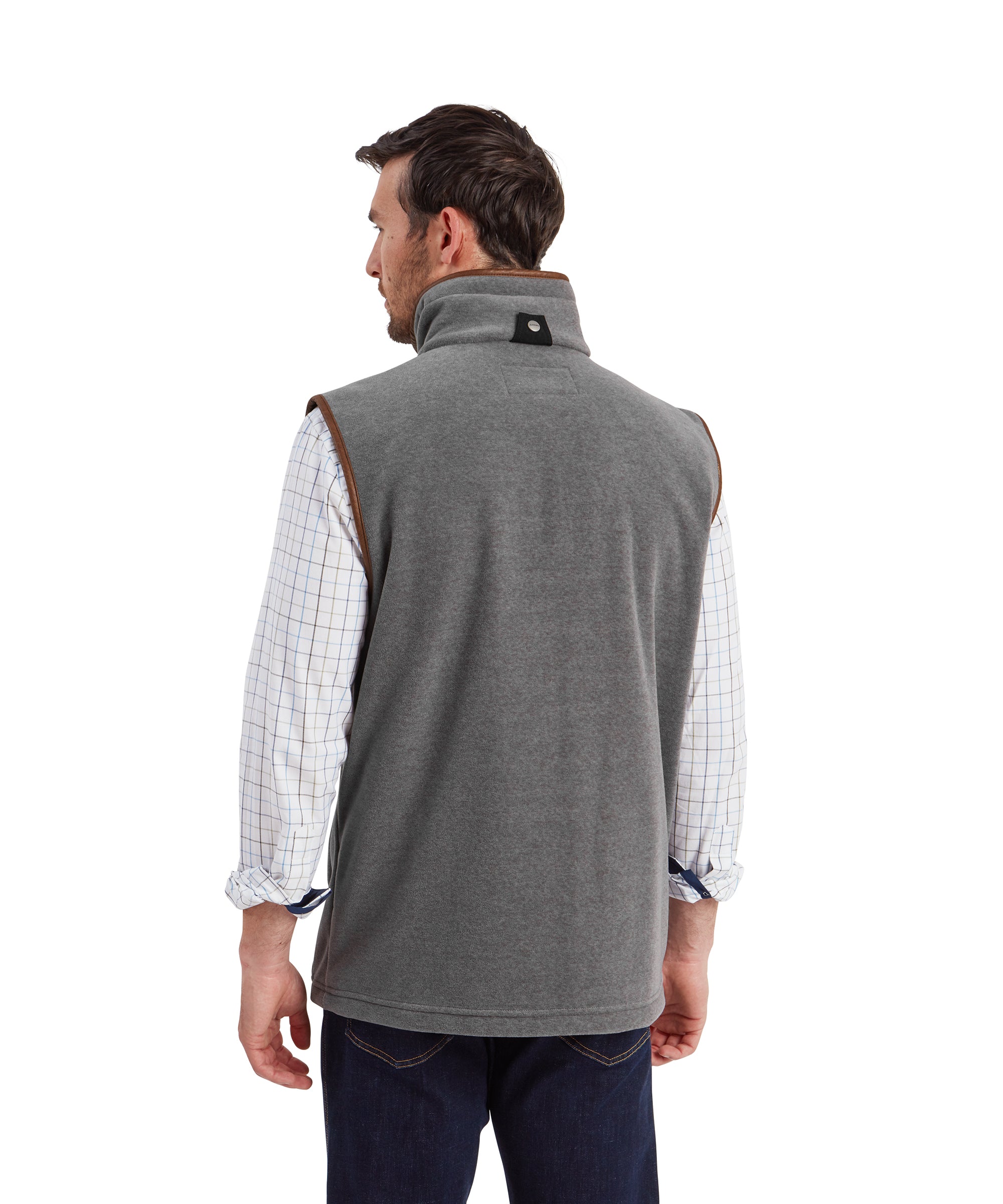 A rear view of a man wearing the Schöffel Oakham Fleece Gilet for Men in Light Grey highlighting the loose fit of the gilet. From the rear you can see the Schöffel buttoned loop with a black canvas fabric and the faux leather trim finishes.