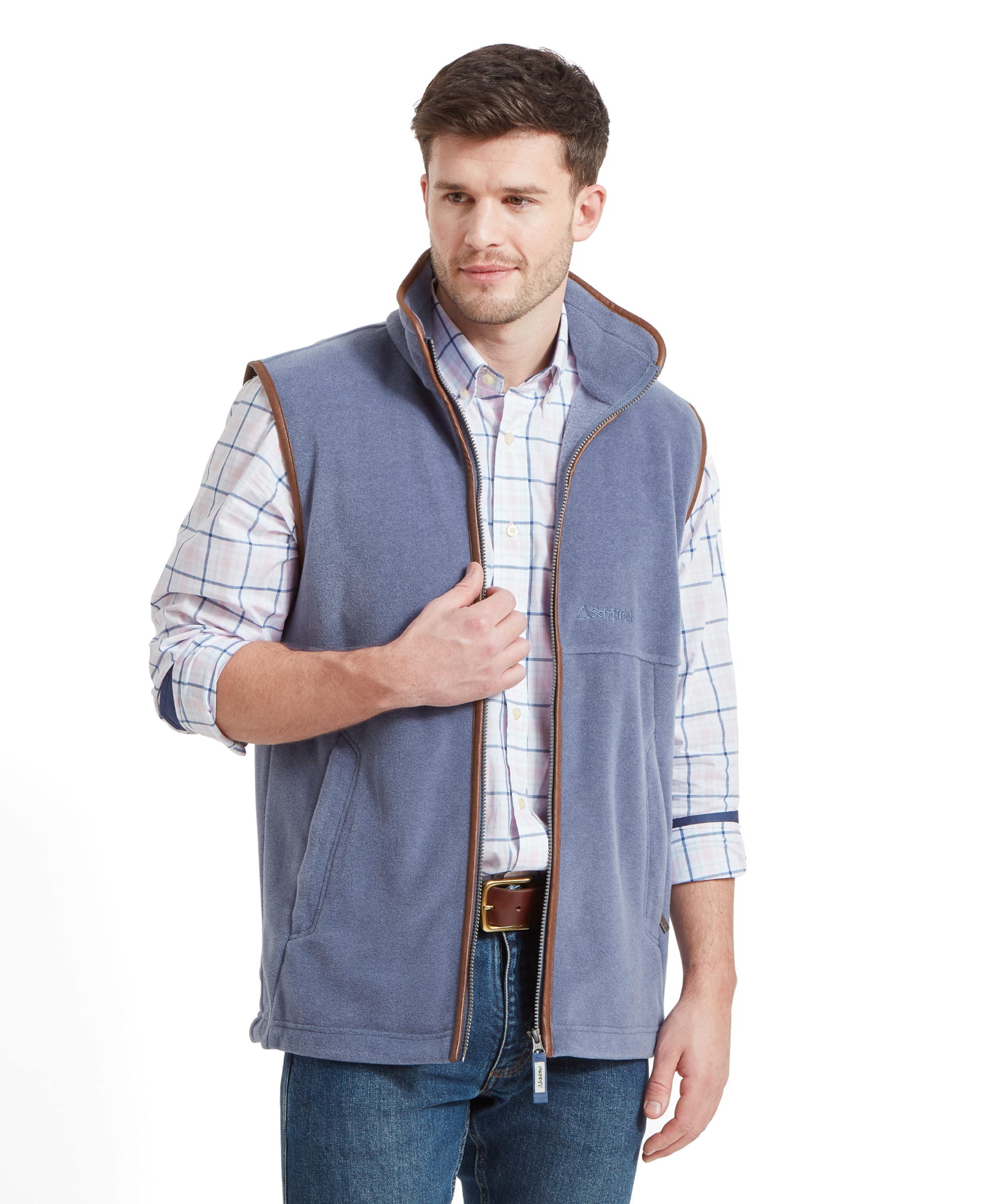 Mid body shot of a man wearing the Schöffel Oakham Fleece Gilet for Men in Light Blue open with a check shirt, denim jeans and a brown leather belt.