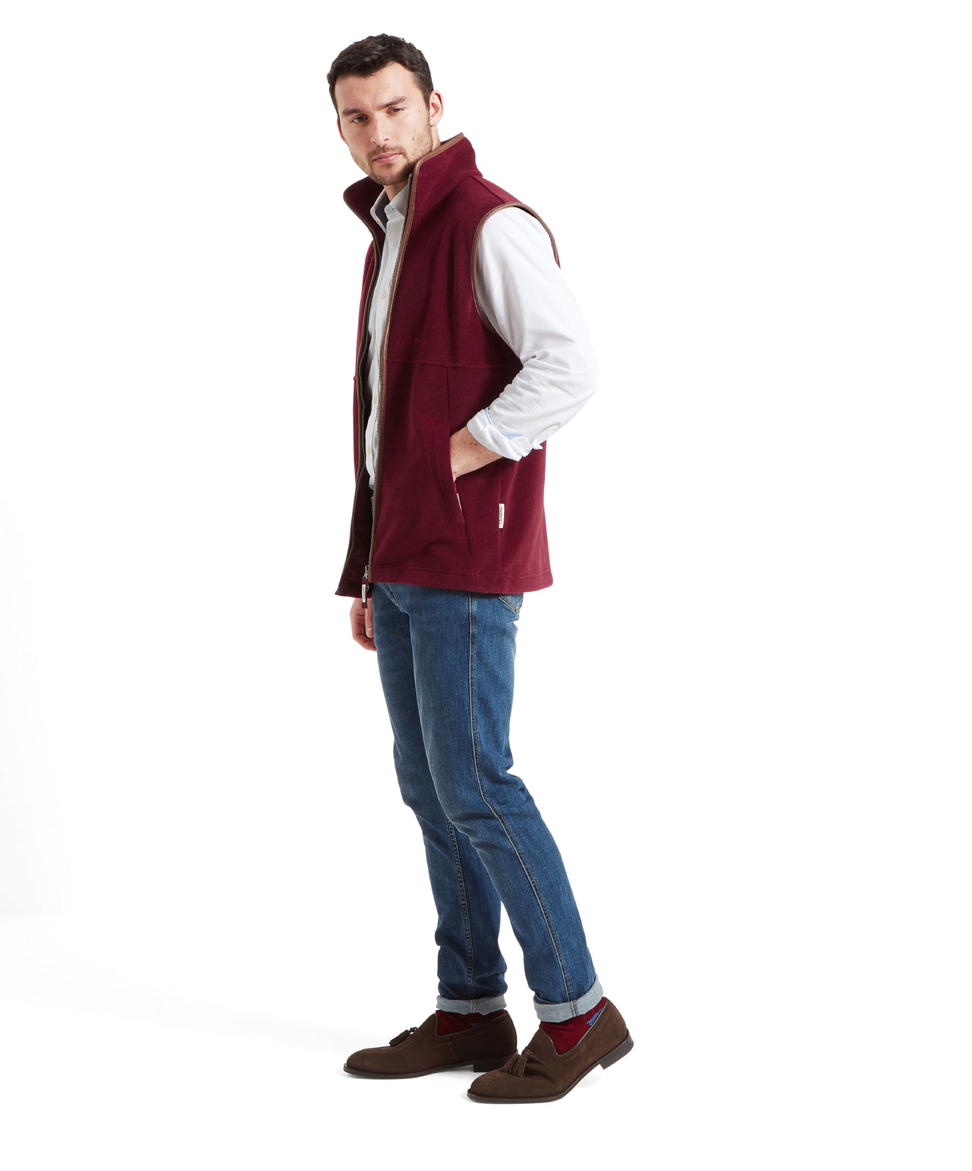 Side view of the model wearing the Schöffel Oakham Fleece Gilet for Men in Red, showcasing the fit and design from the side.