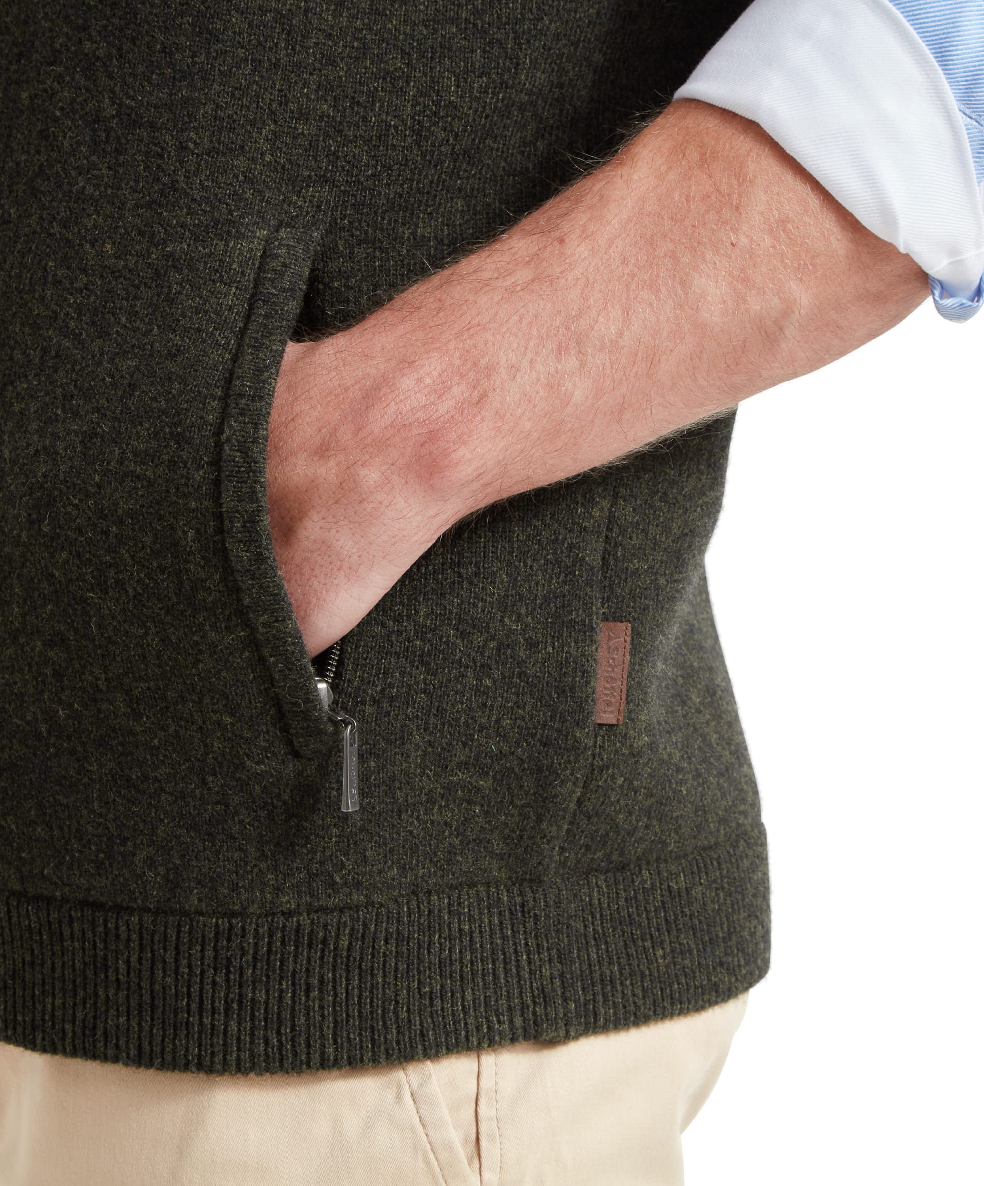 A detailed image of the pocket and zipper of the Schöffel Orkney Merino Gilet for Men in Green, showcasing the fabric and design.