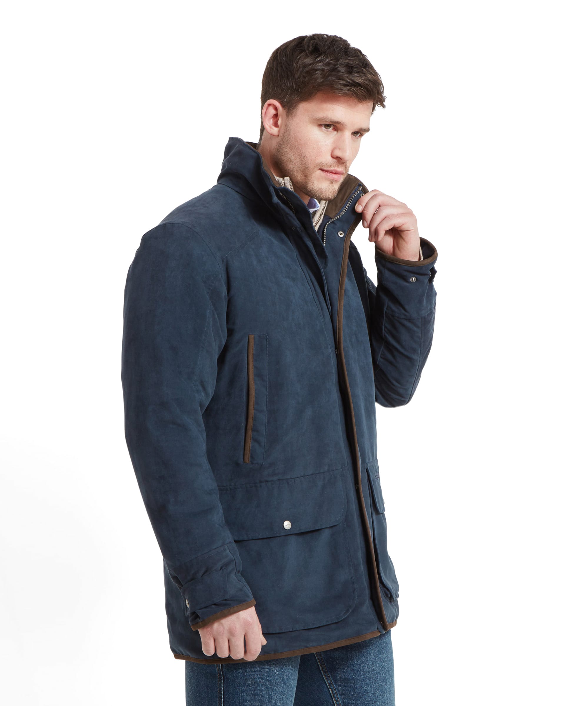 Side view of the model adjusting the collar of the Schöffel Oundle Country Coat, highlighting the coat's sleek design and deep navy color.