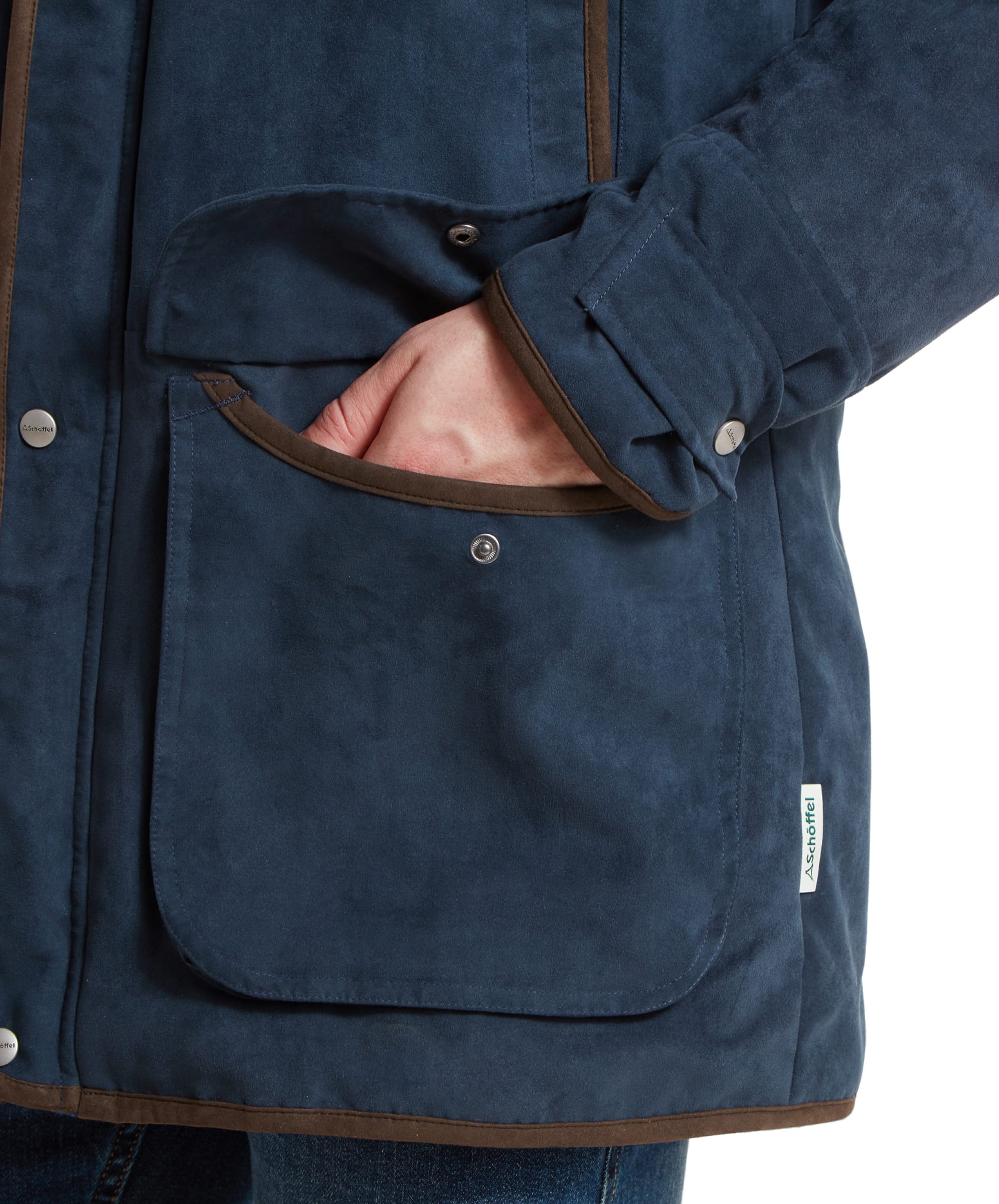 Close-up of the coat's billow pocket, with a hand inside, demonstrating the coat's practical and stylish features.