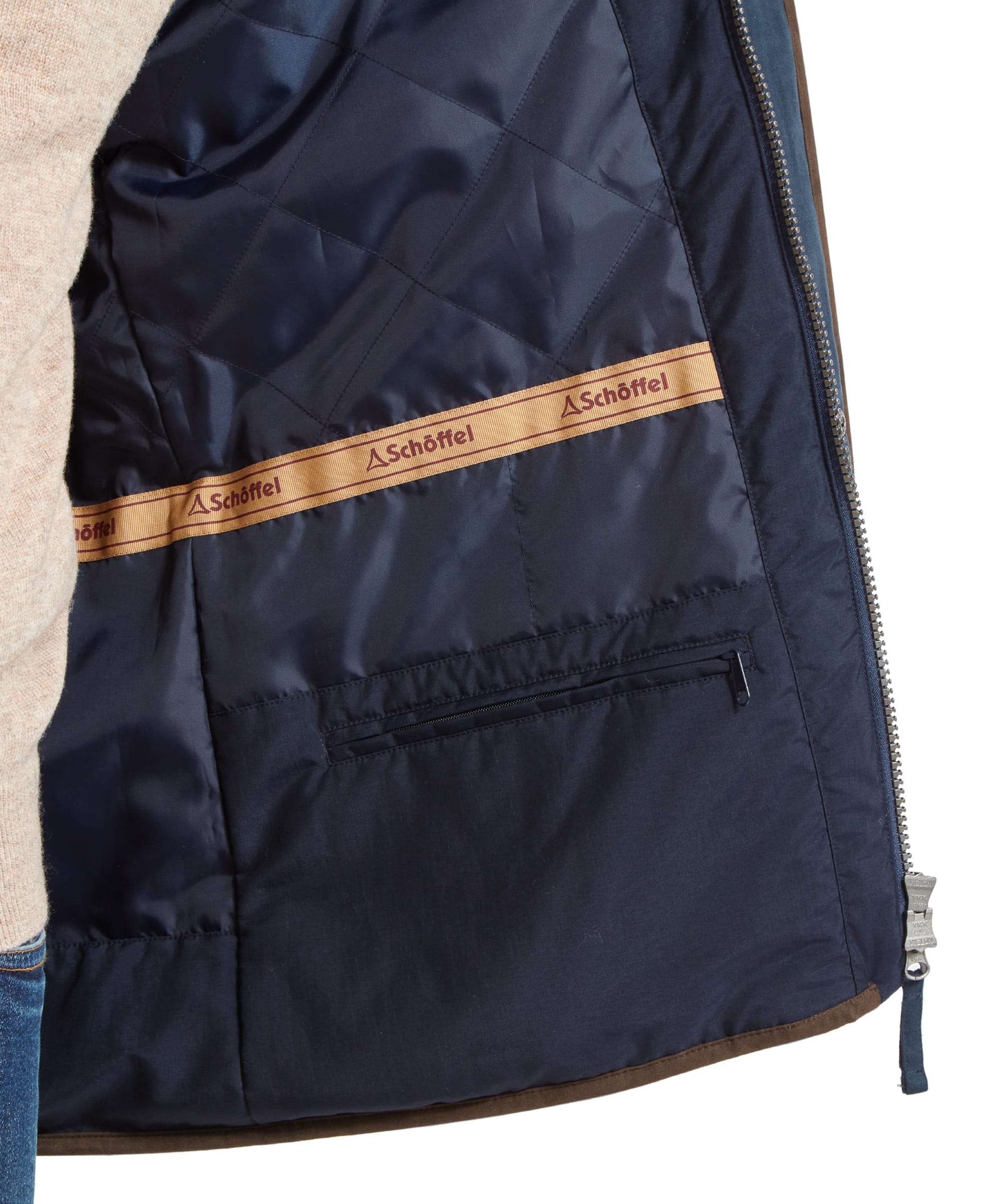 Inside view of the coat's lining, showing the Schöffel branding and an inner security pocket, emphasizing the coat's functional design.