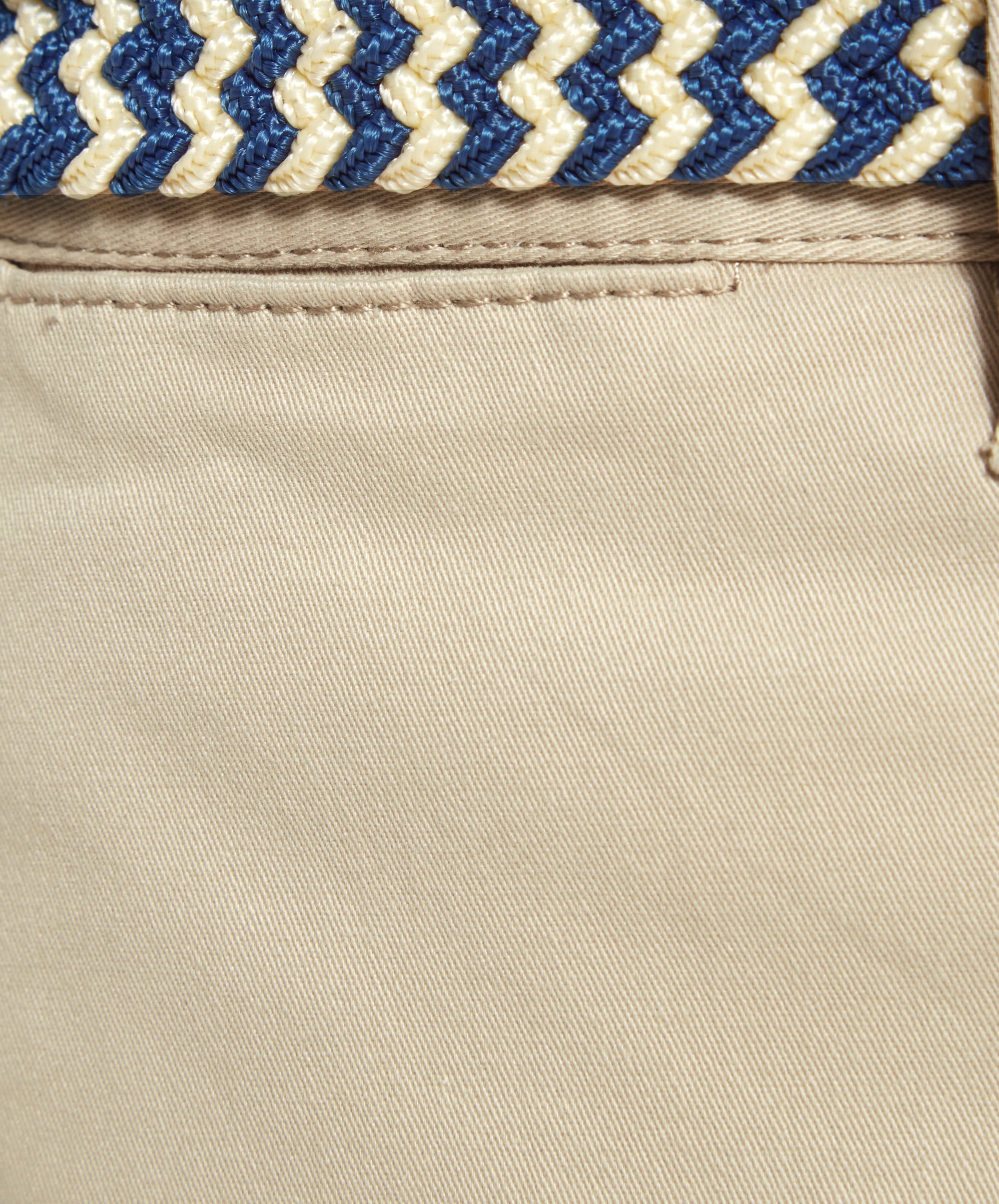 Extreme close-up of the belt loop and fabric texture of Schöffel Paul Shorts for Men in Beige, highlighting the quality of the material