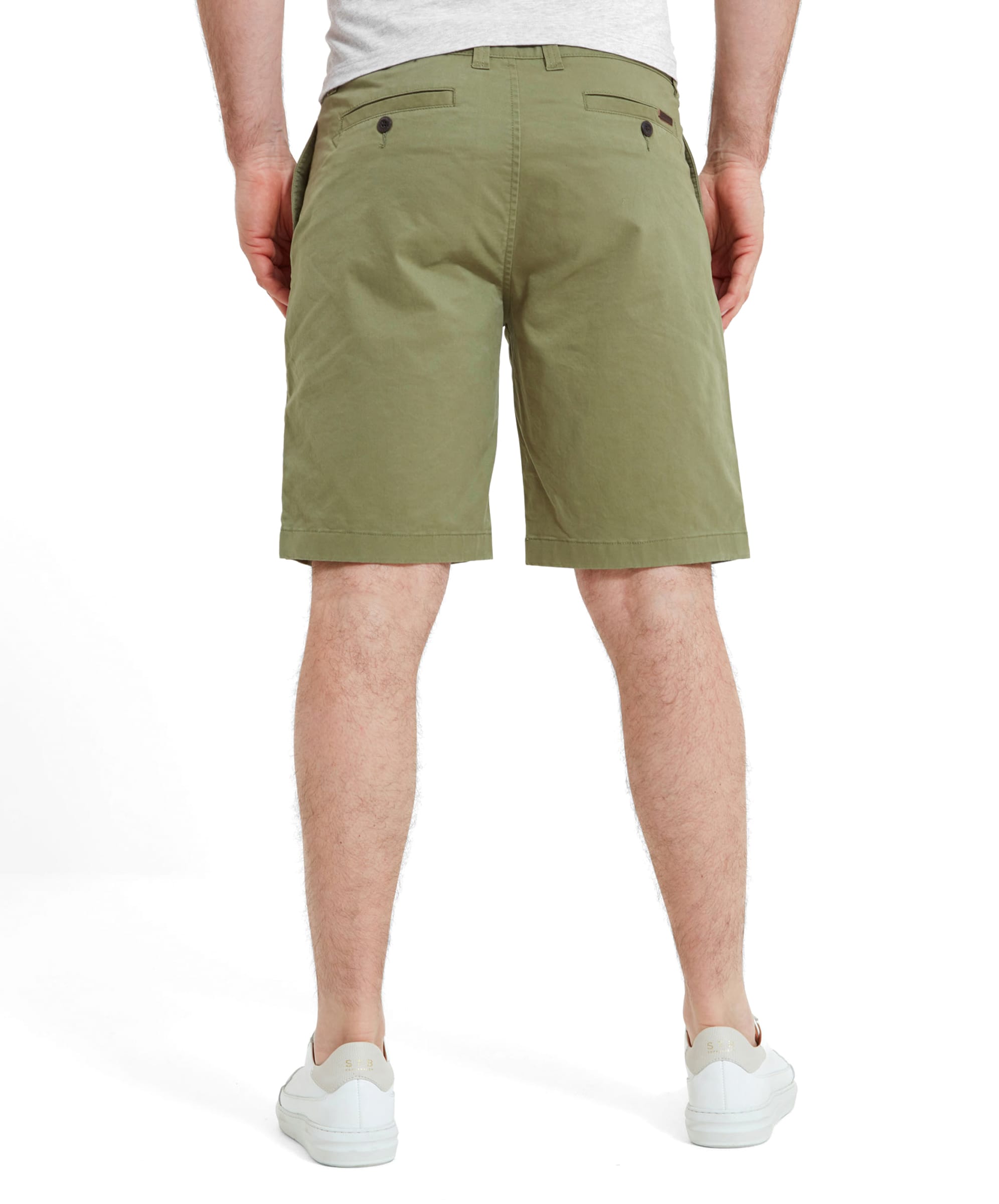 Rear view of the Schöffel Paul Shorts for Men in Green. The model's stance highlights the shorts' fit and back pocket details.