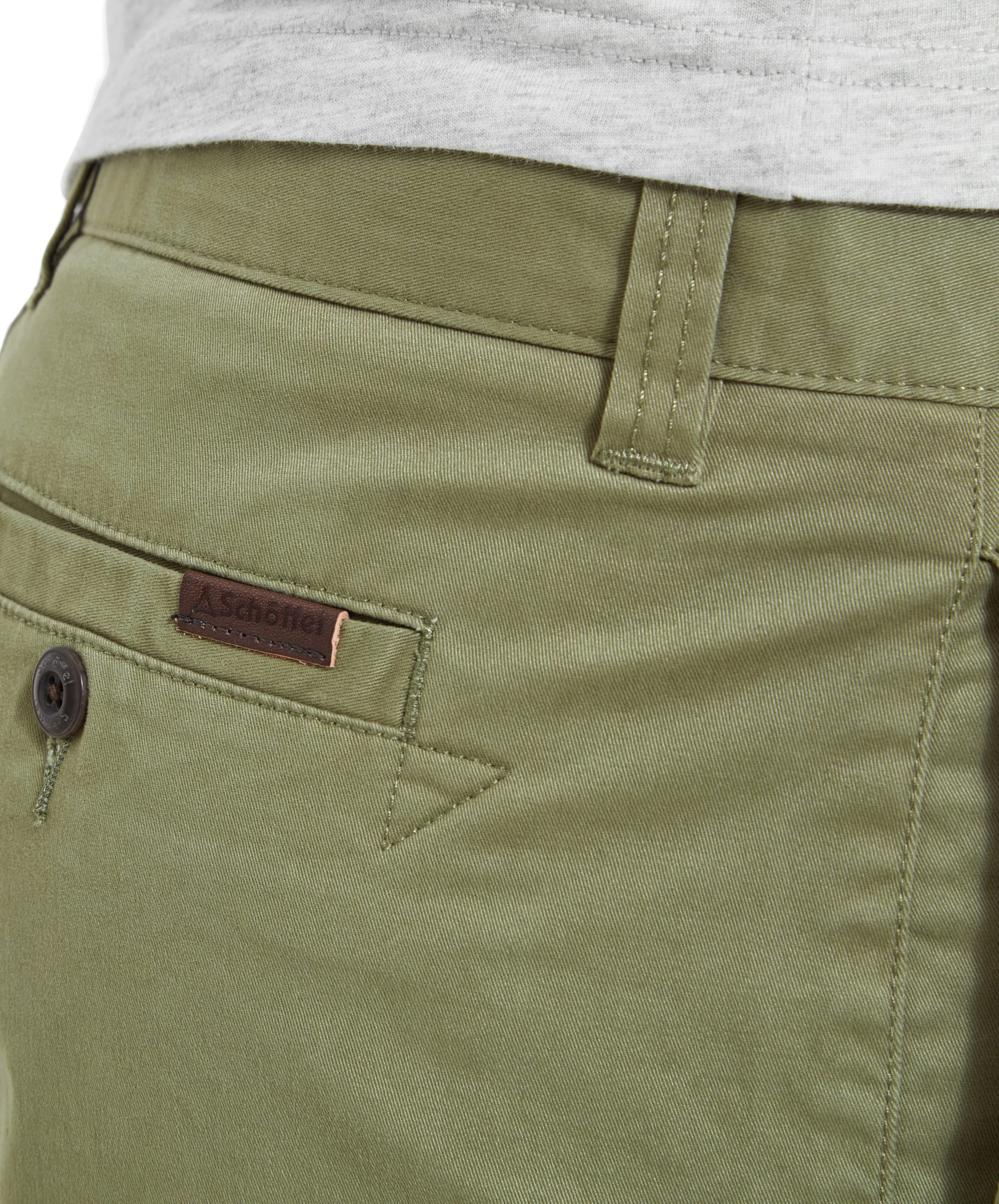 Close-up of the back pocket and belt loop of the Schöffel Paul Shorts for Men in Green. The detailed shot showcases the fabric texture and the Schöffel logo tag.