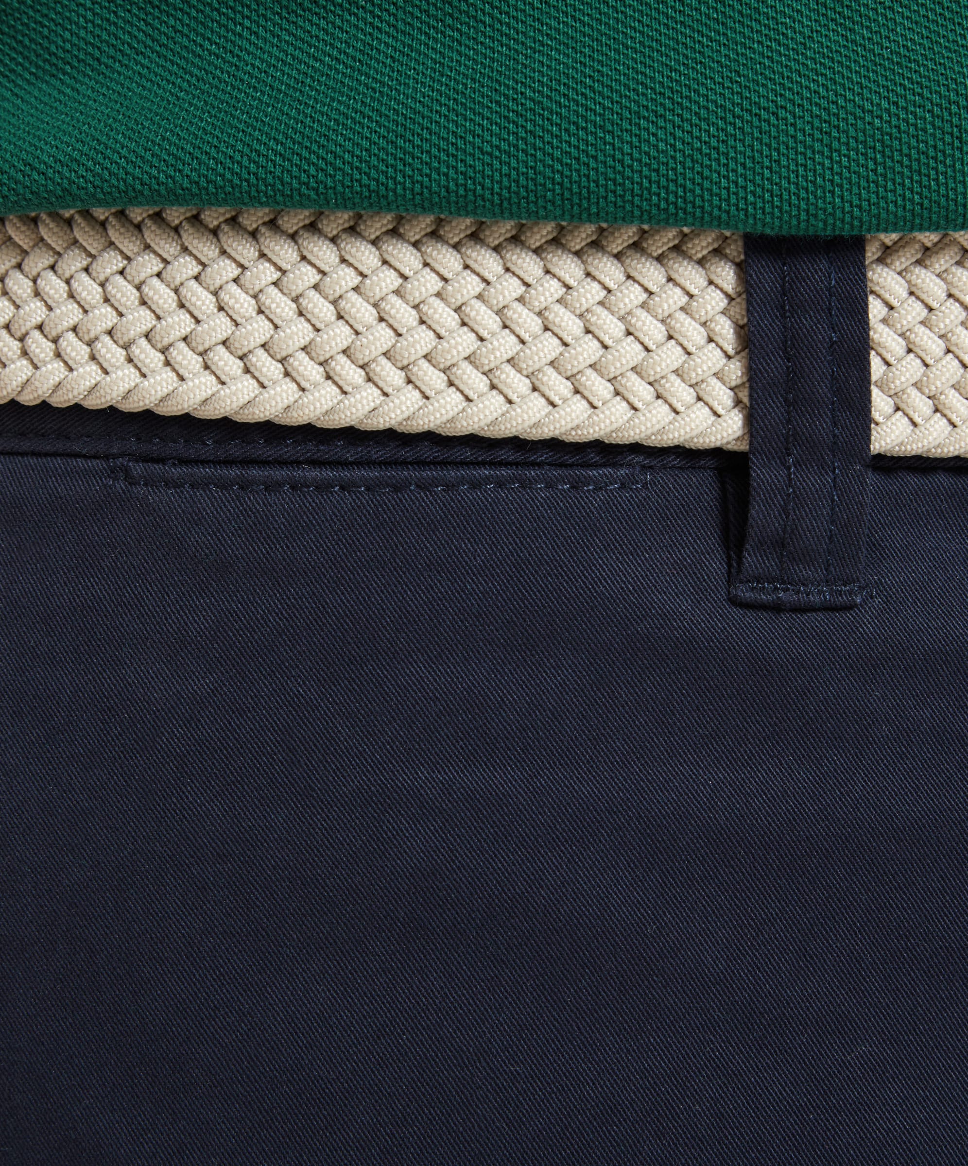 Detailed view of the belt loops and waistband on the Schöffel Paul Shorts for Men in Navy, with a cream-colored braided belt.