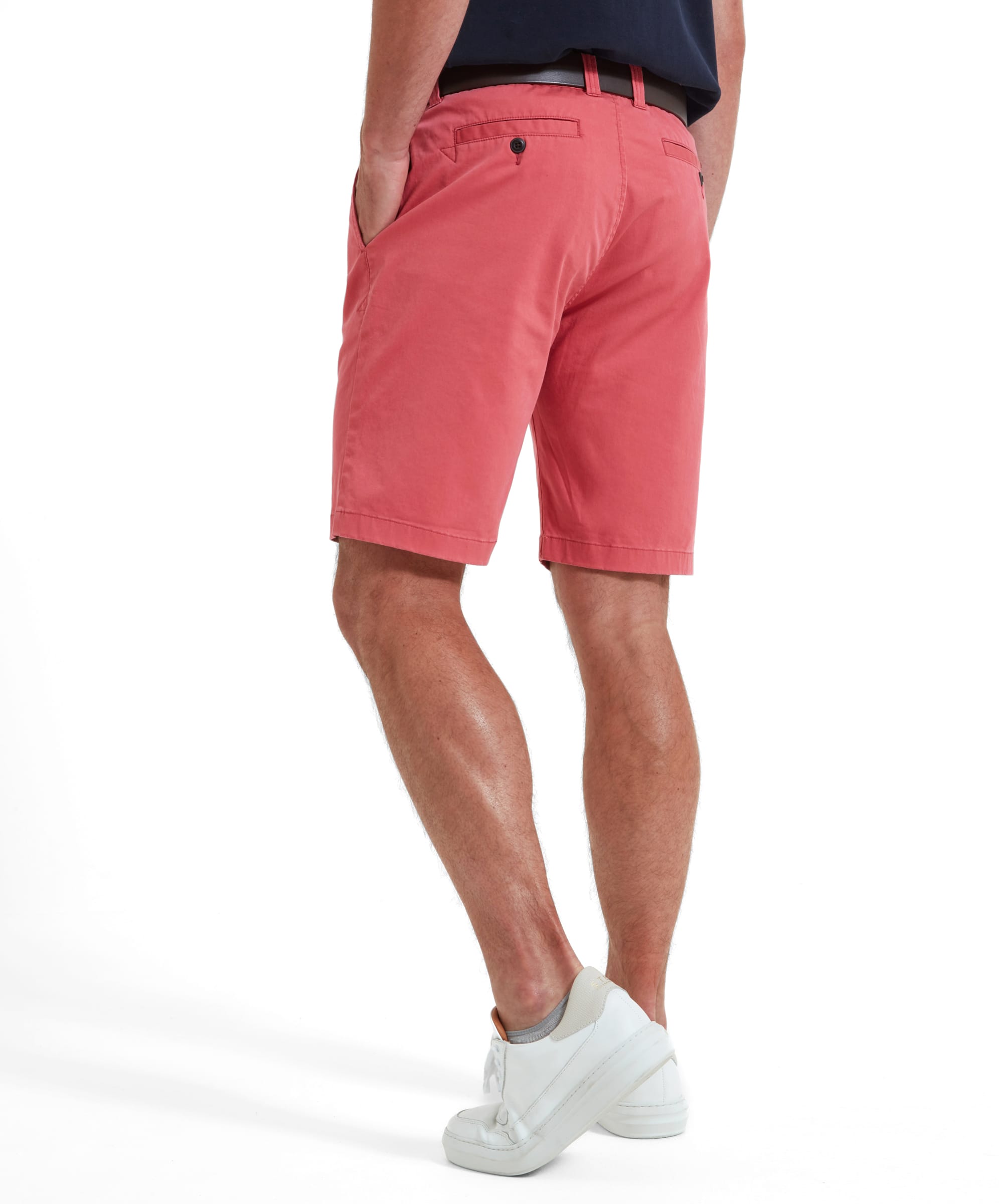 A rear view of a man wearing Schöffel Paul Shorts for Men in Pink, showing the back pockets.