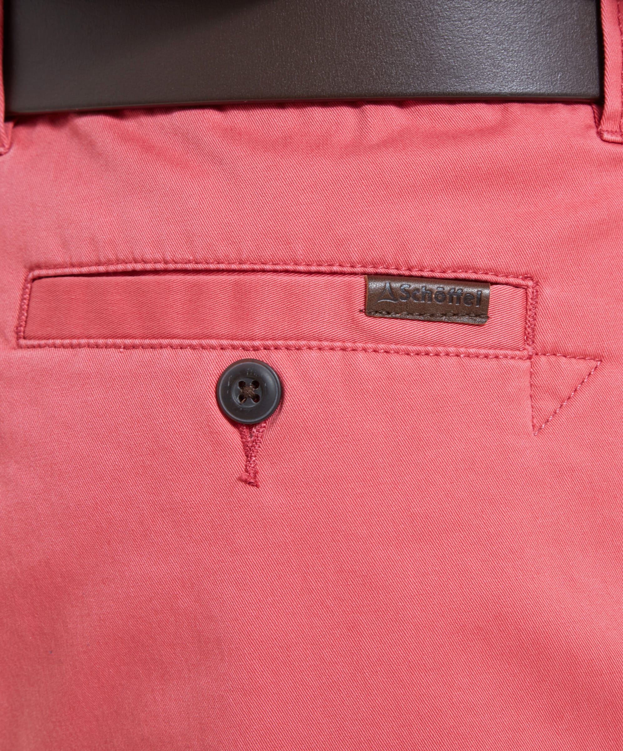 Close-up of the back pocket of Schöffel Paul Shorts for Men in Pink, featuring the Schöffel brand label.