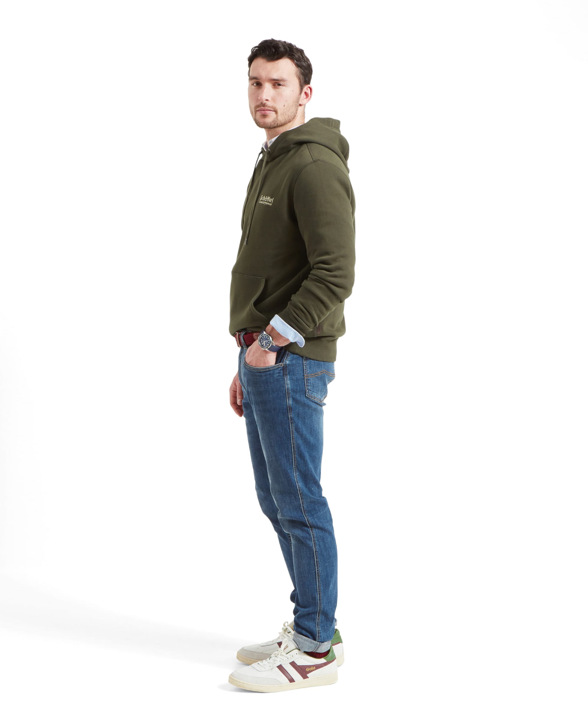 Side view of a man wearing Schöffel Pentire Heritage Hoodie for Men in Green, showing the fit and hood details.