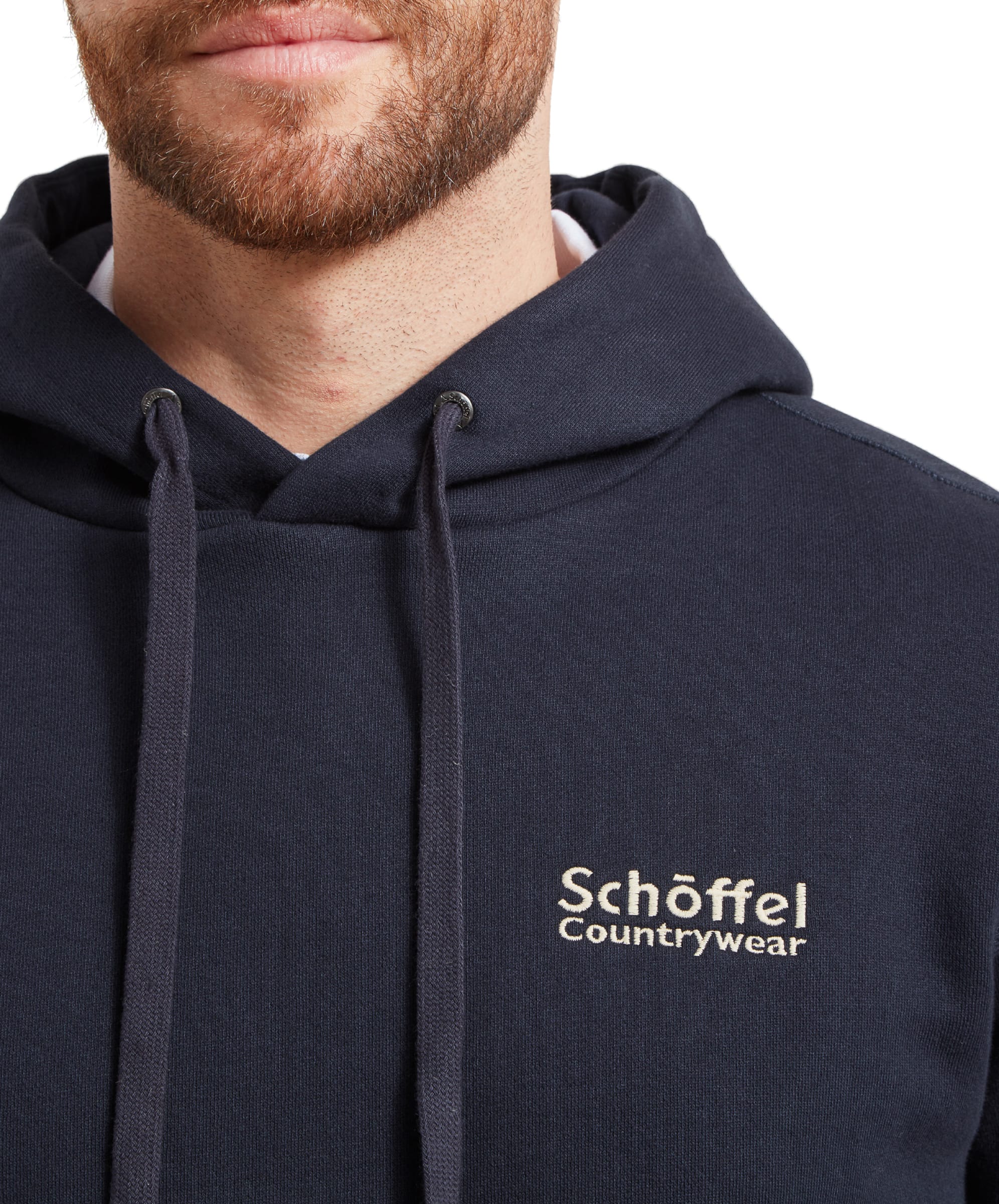 Close-up of the Schöffel Countrywear logo on the Schöffel Pentire Heritage Hoodie for Men in Navy. The embroidery is detailed, adding a touch of quality and style to the hoodie.