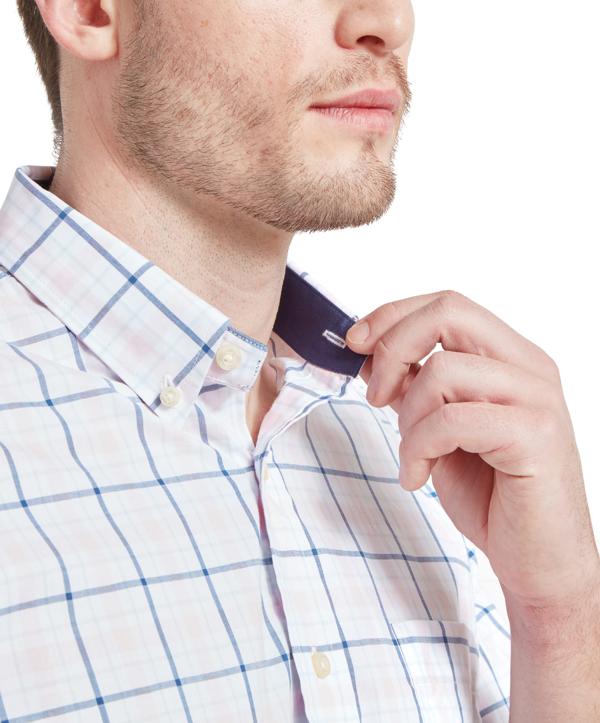 A close-up of a man adjusting the collar of Schöffel Polstead Classic Shirt for Men in Blue, highlighting the fabric detail.