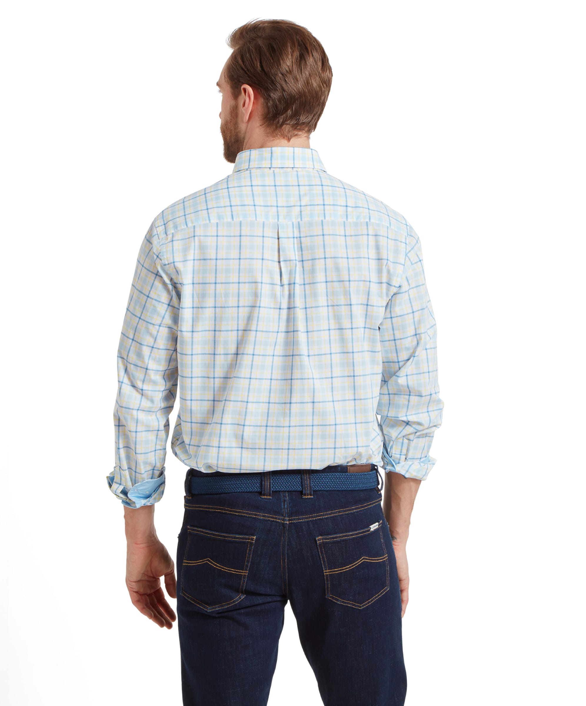 Rear view of the Schöffel Polstead Classic Shirt for Men in Blue and Yellow, showing the back details while the model stands with both hands in his pockets.