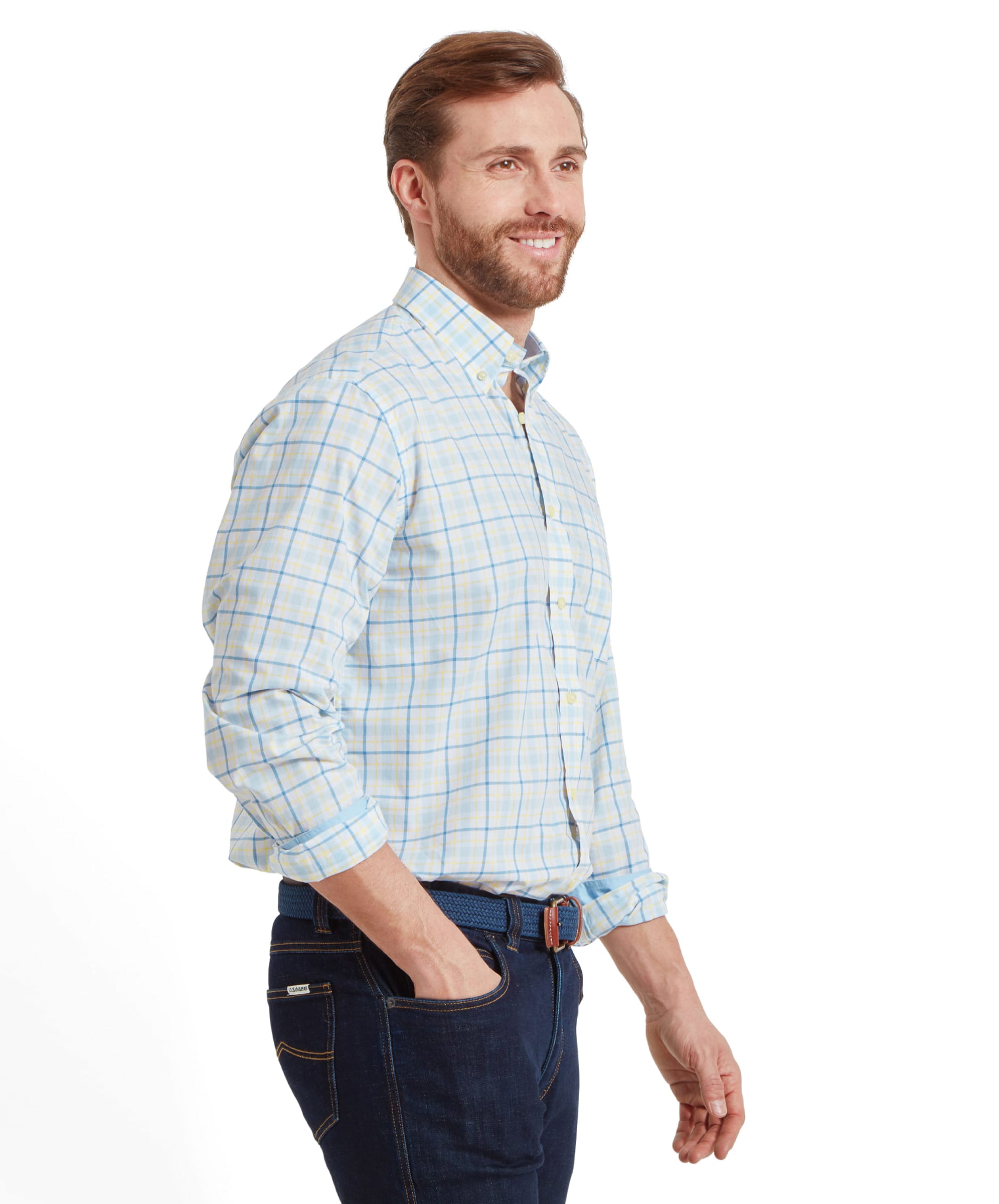 Side profile of the man wearing the Schöffel Polstead Classic Shirt for Men in Blue and Yellow, with a relaxed smile and one hand in his pocket.