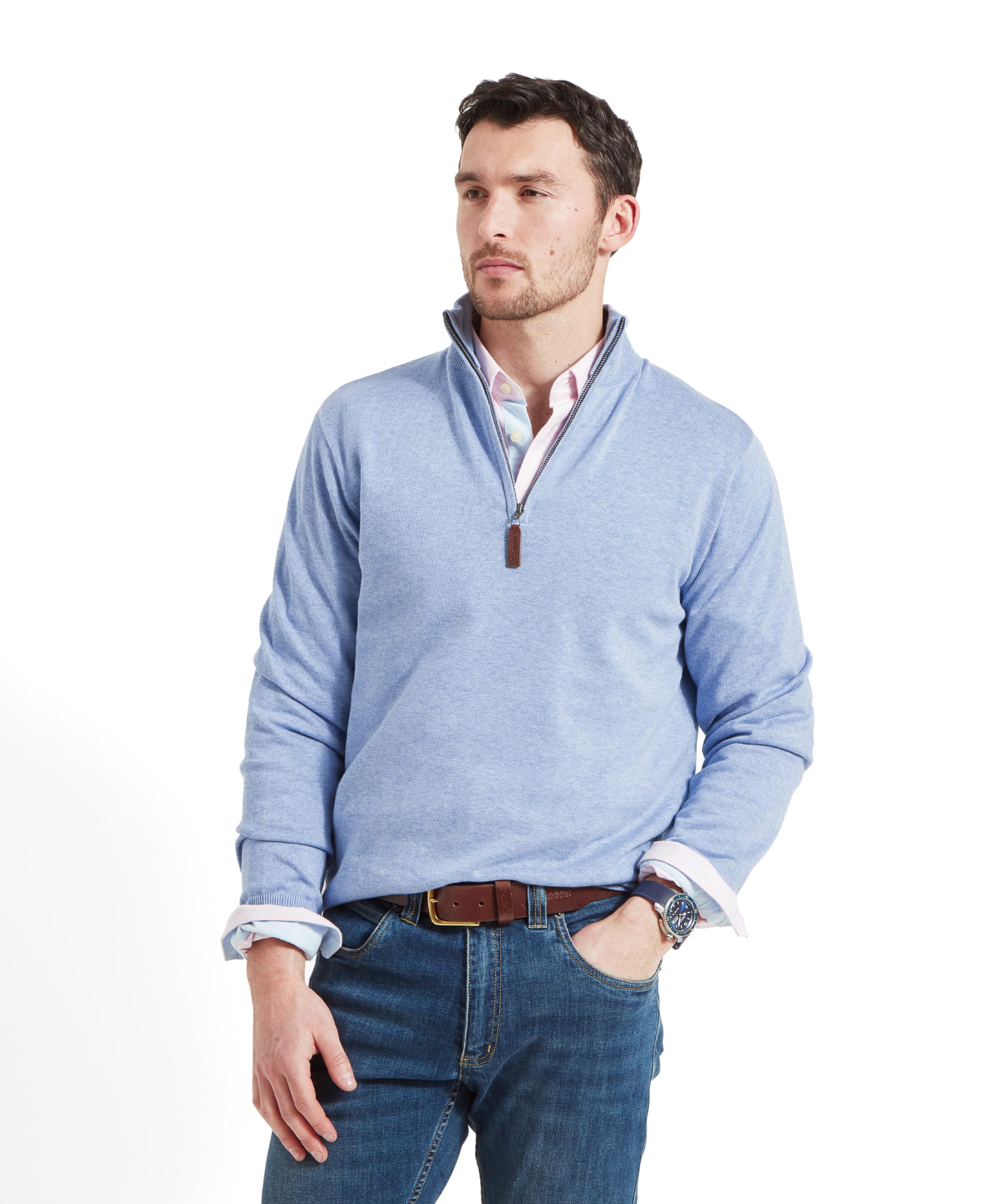 A man wearing the Schöffel Porthmeor Pima Cotton 1/4 Zip for Men in Blue, standing with a confident expression.