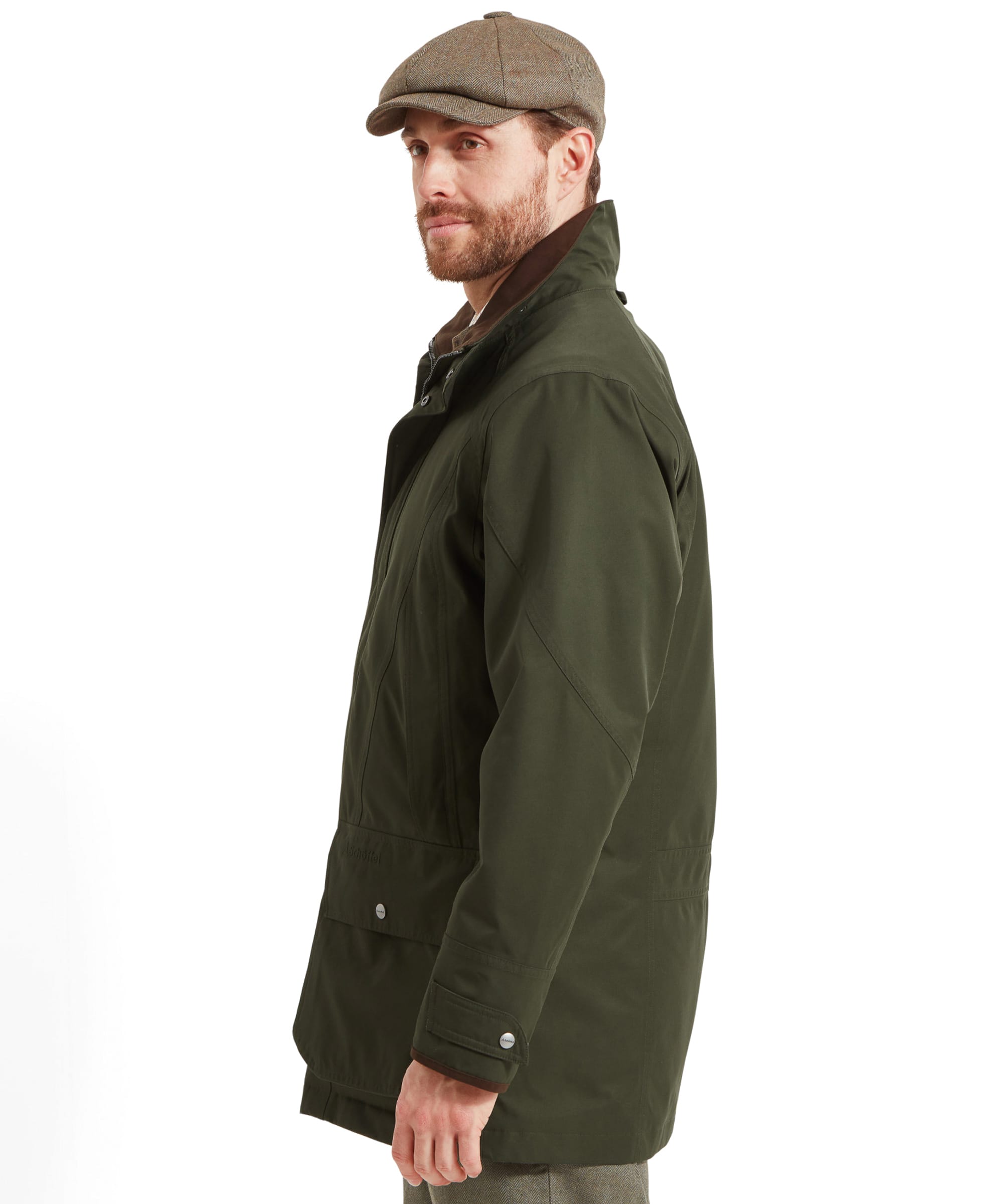 Side profile of a man in the Schöffel Ptarmigan Extreme II for Men in Green, looking to the side