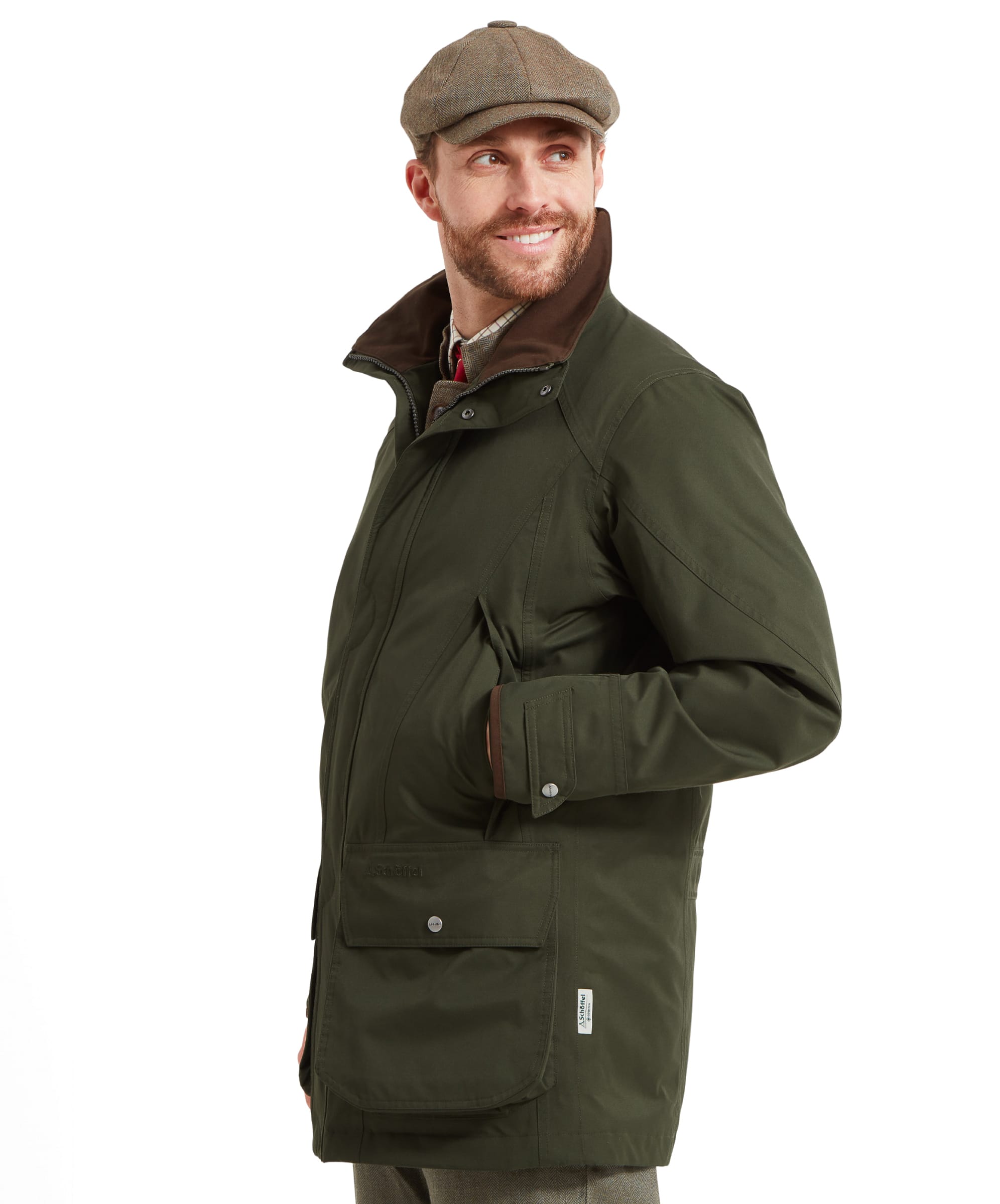 Another view of a man in the Schöffel Ptarmigan Extreme II for Men in Green, smiling