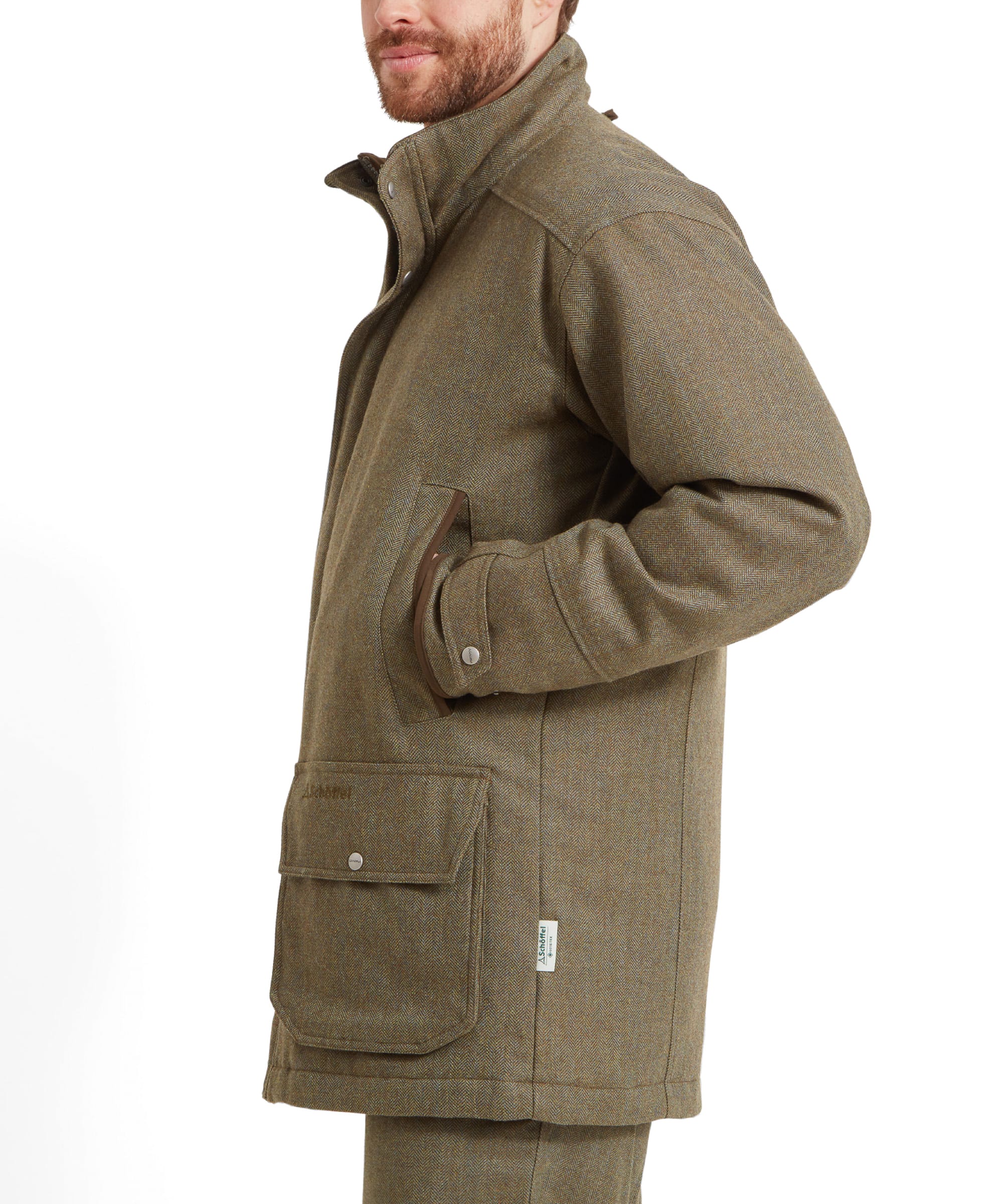 Side profile of a man in the Schöffel Ptarmigan Tweed Classic Coat for Men in Green, showing the coat’s fit and pockets.