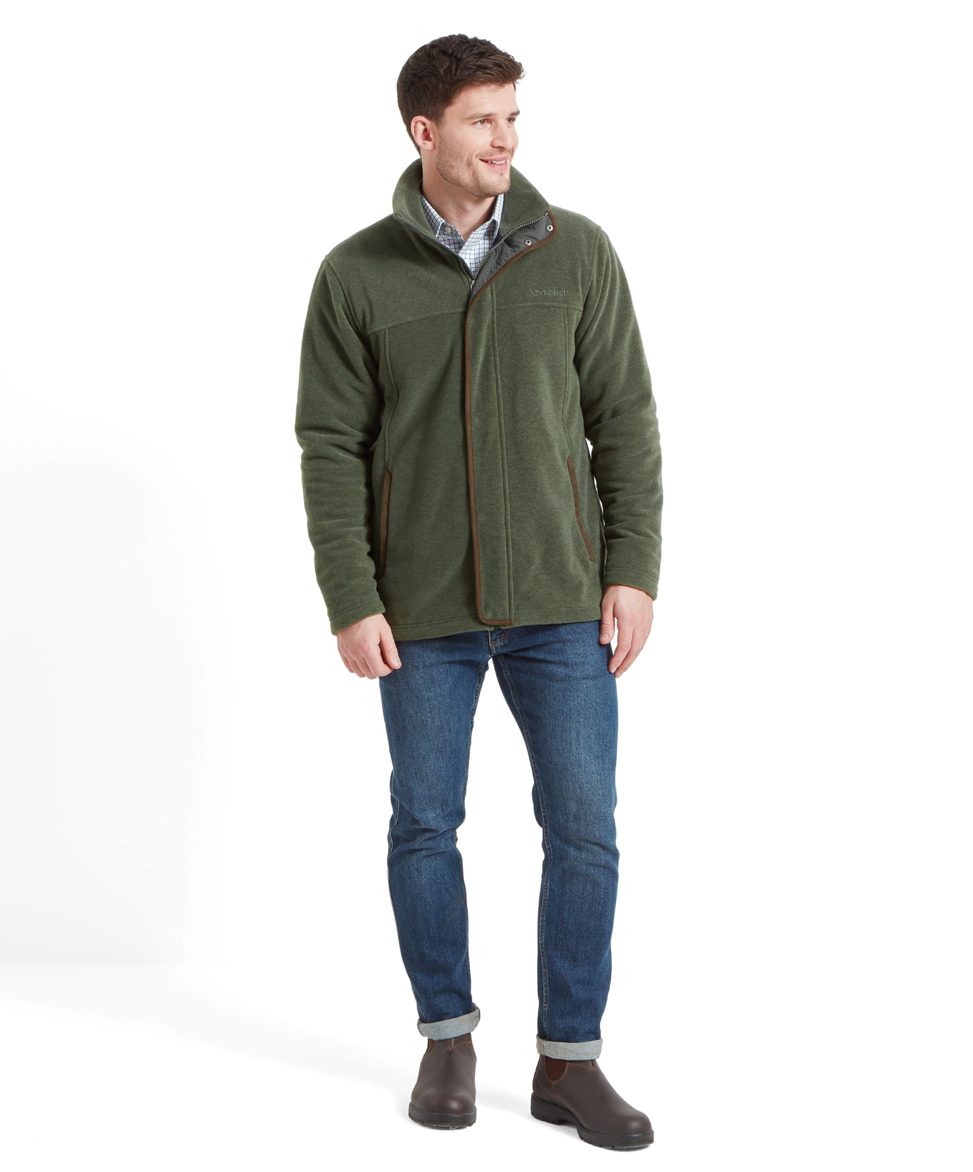 Full body view of a man modelling the Schöffel Rutland Fleece for Men in Green whilst wearing denim jeans and dark brown boots. He stands with his hands to his side and looking to his right.