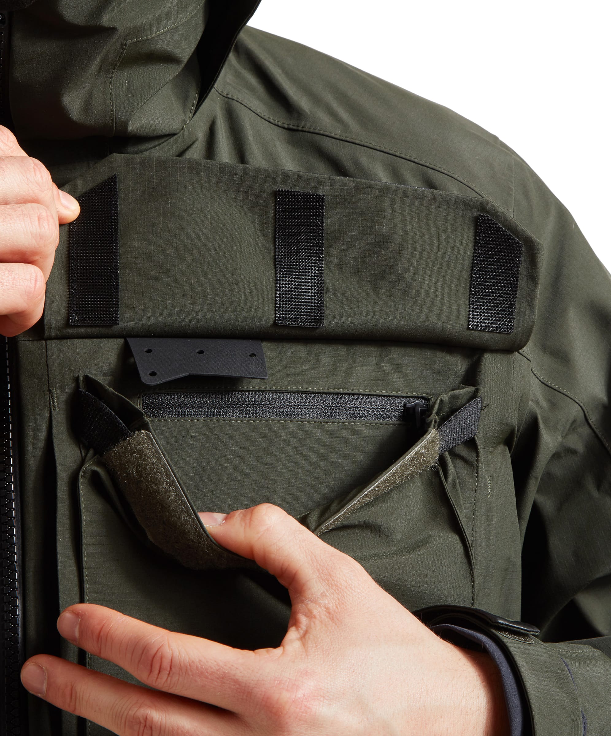 Close-up of the other check pocket and the velcro detail on the Schöffel Salar II Wading Jacket for Men in Green, highlighting another security pocket within and the elasticated side tabs.