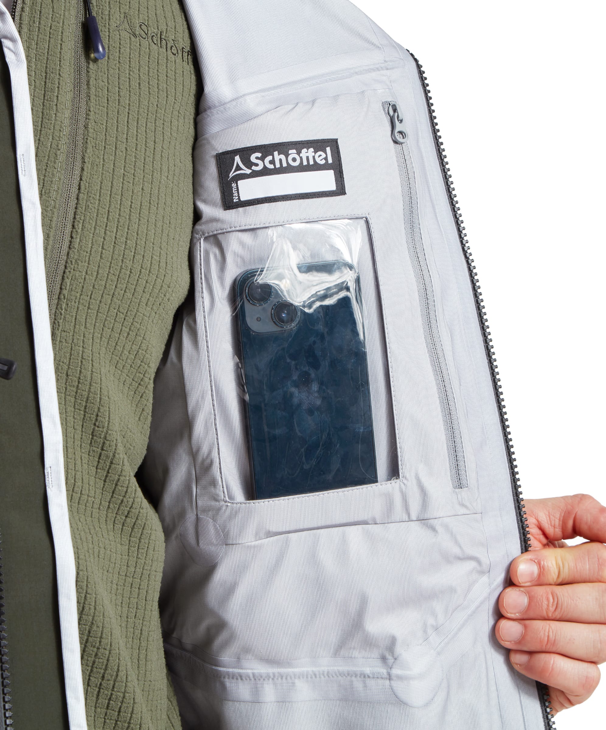 Close-up on the inside of the Schöffel Salar II Wading Jacket for Men in Green highlighting a waterproof pocket for phones and other technology.