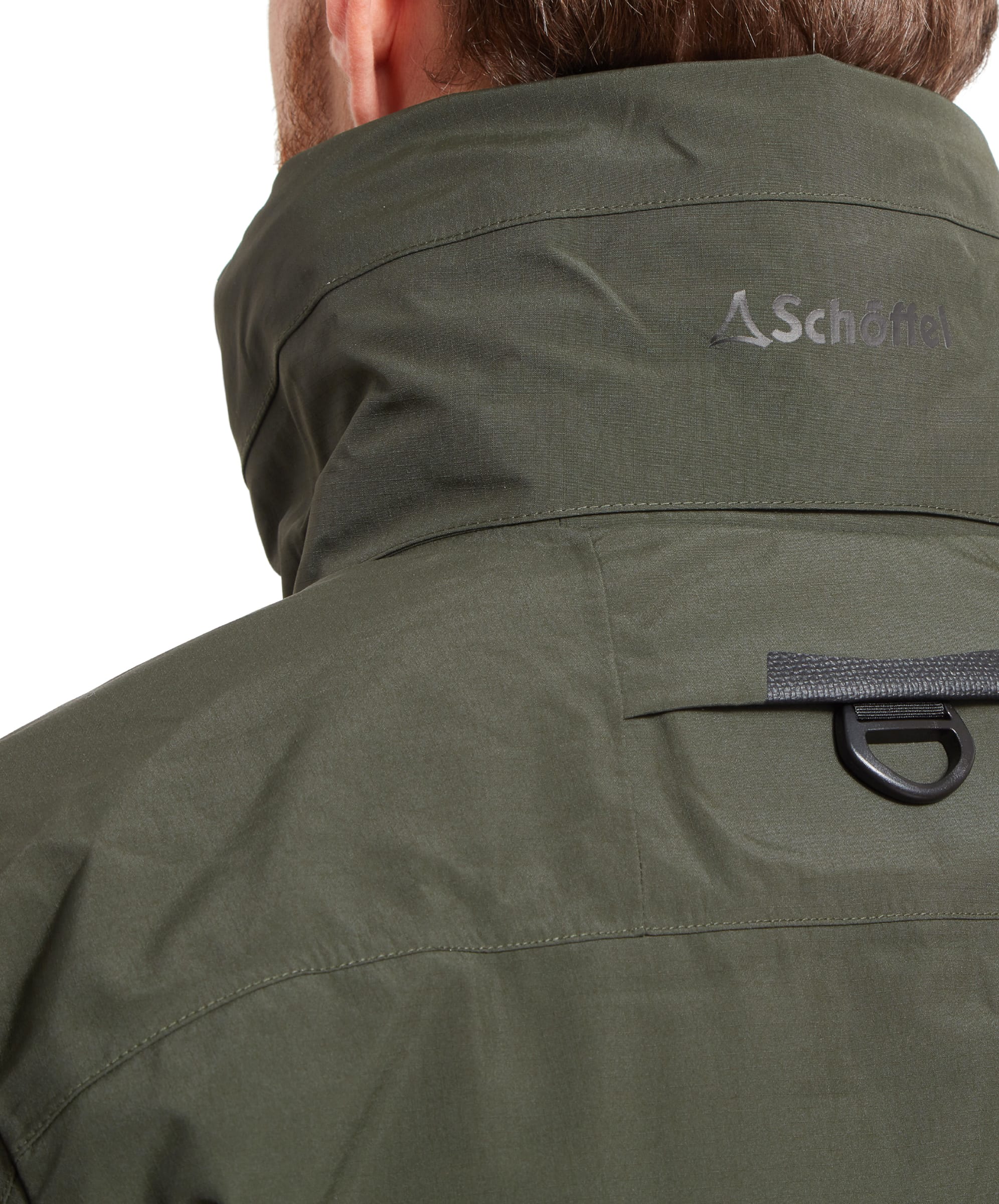 Close-up to the back of the neck on the Schöffel Salar II Wading Jacket for Men in Green highlighting the d-ring and Schöffel logo. There is also a section for stowing away the hood.