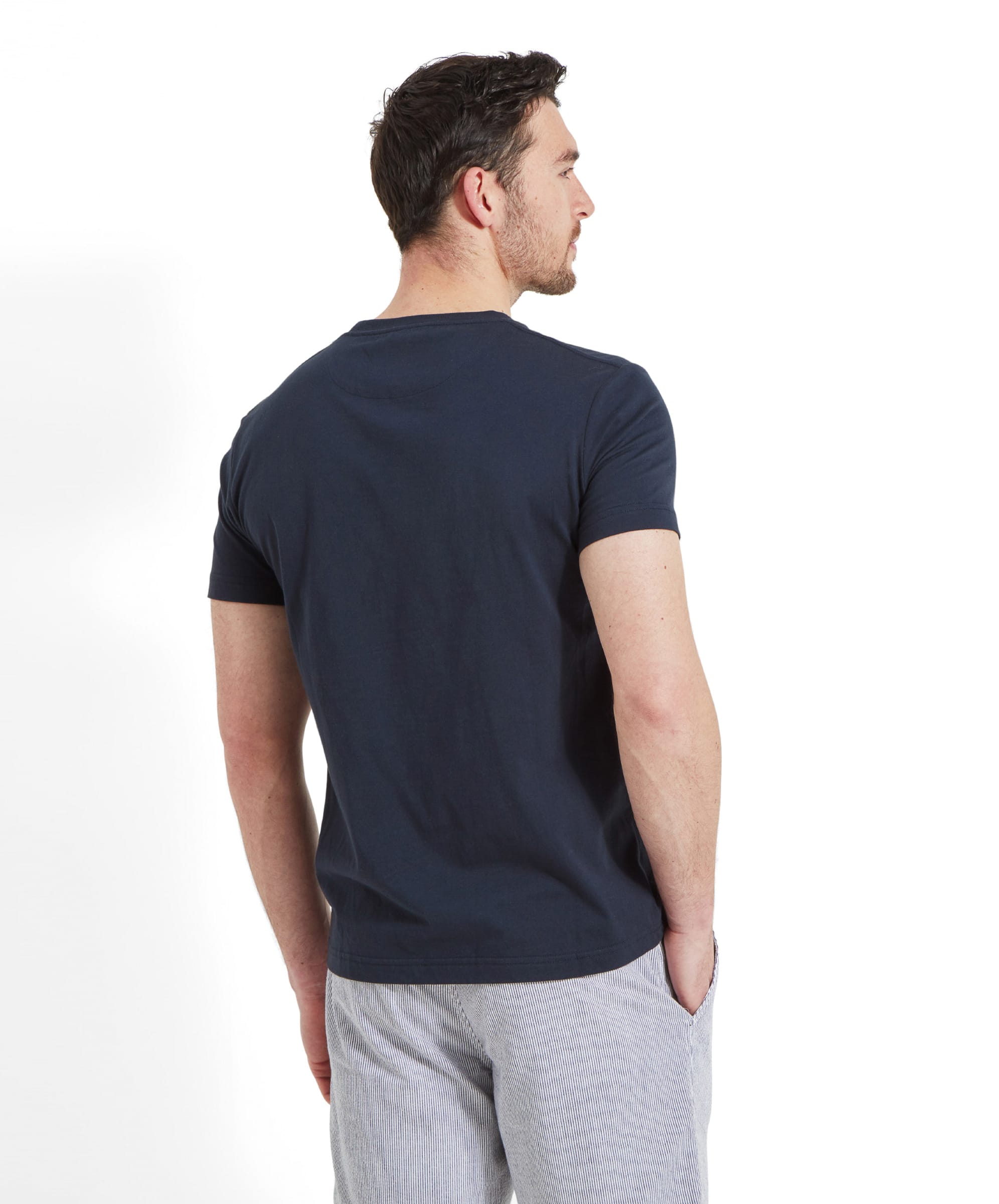 Back view of a man wearing the Schöffel Heritage T-Shirt for Men in Navy highlighting the slim fitting and t-shirt length.