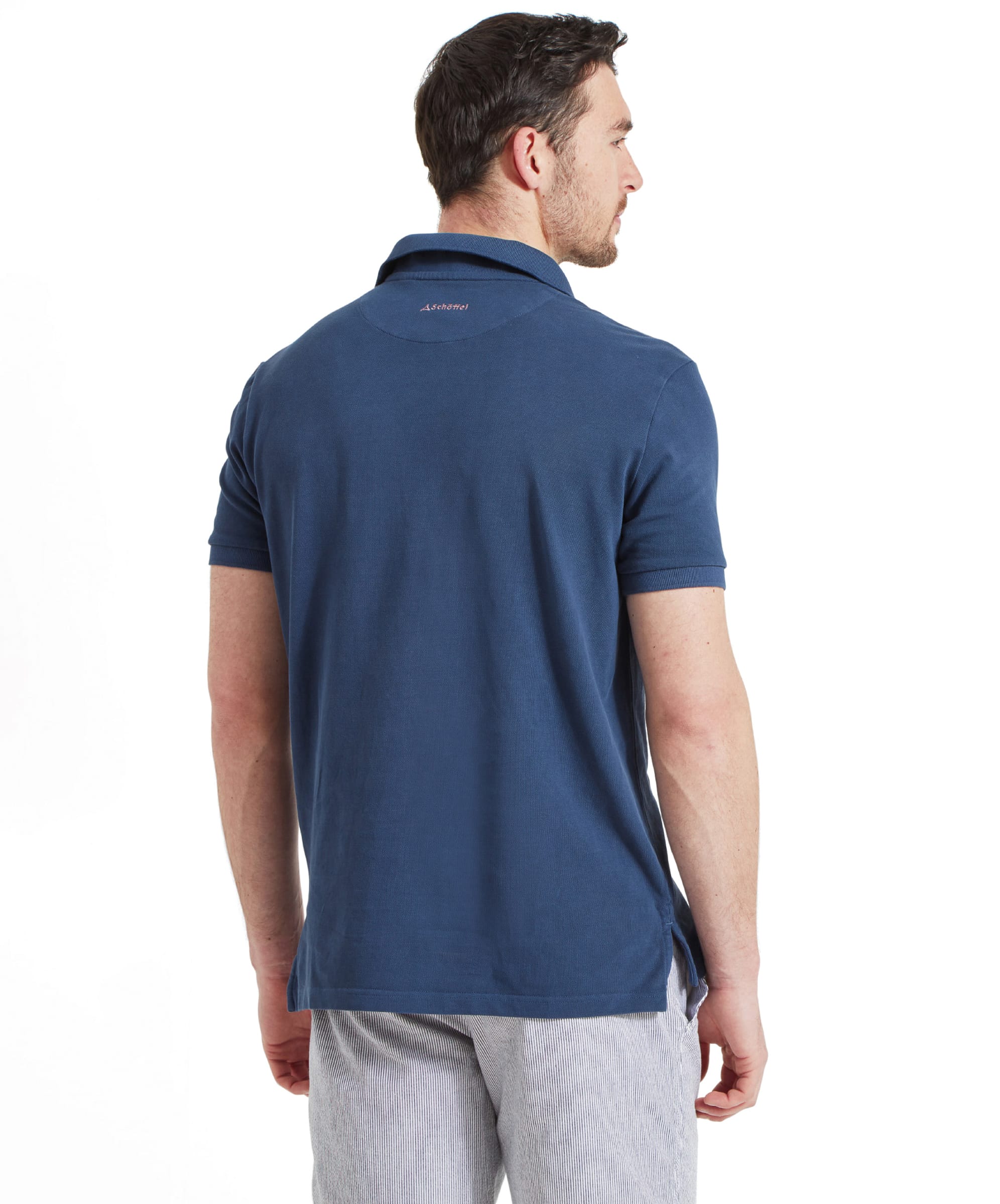 Back view of the Schöffel St Ives Garment Dyed Polo Shirt for Men in Blue highlighting the pink embroidery of the Schöffel branding found on the back of the polo shirt.