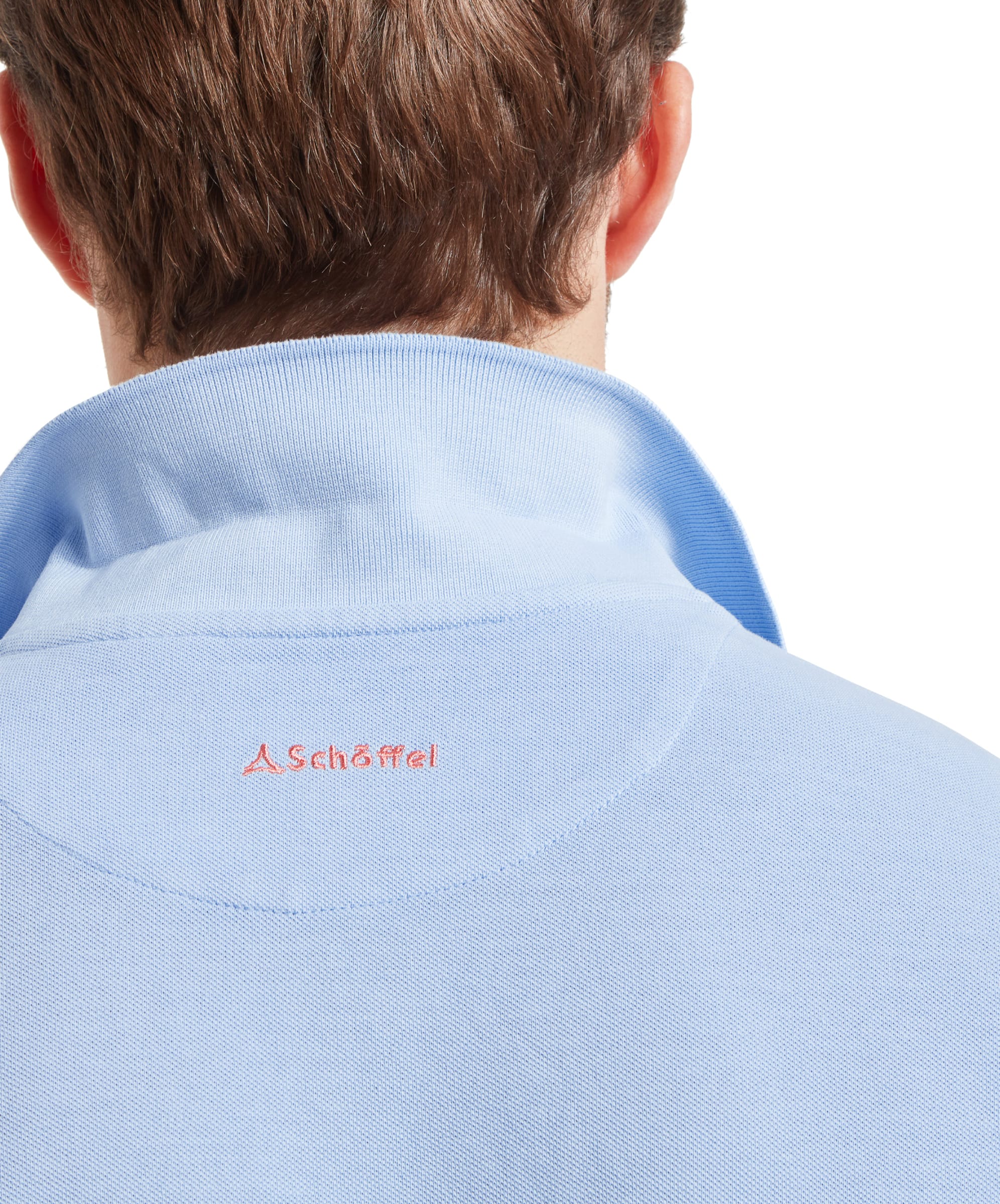 Close-up of the back view on the Schöffel St Ives Garment Dyed Polo Shirt for Men in Light Blue highlighting the pink branded embroidery.