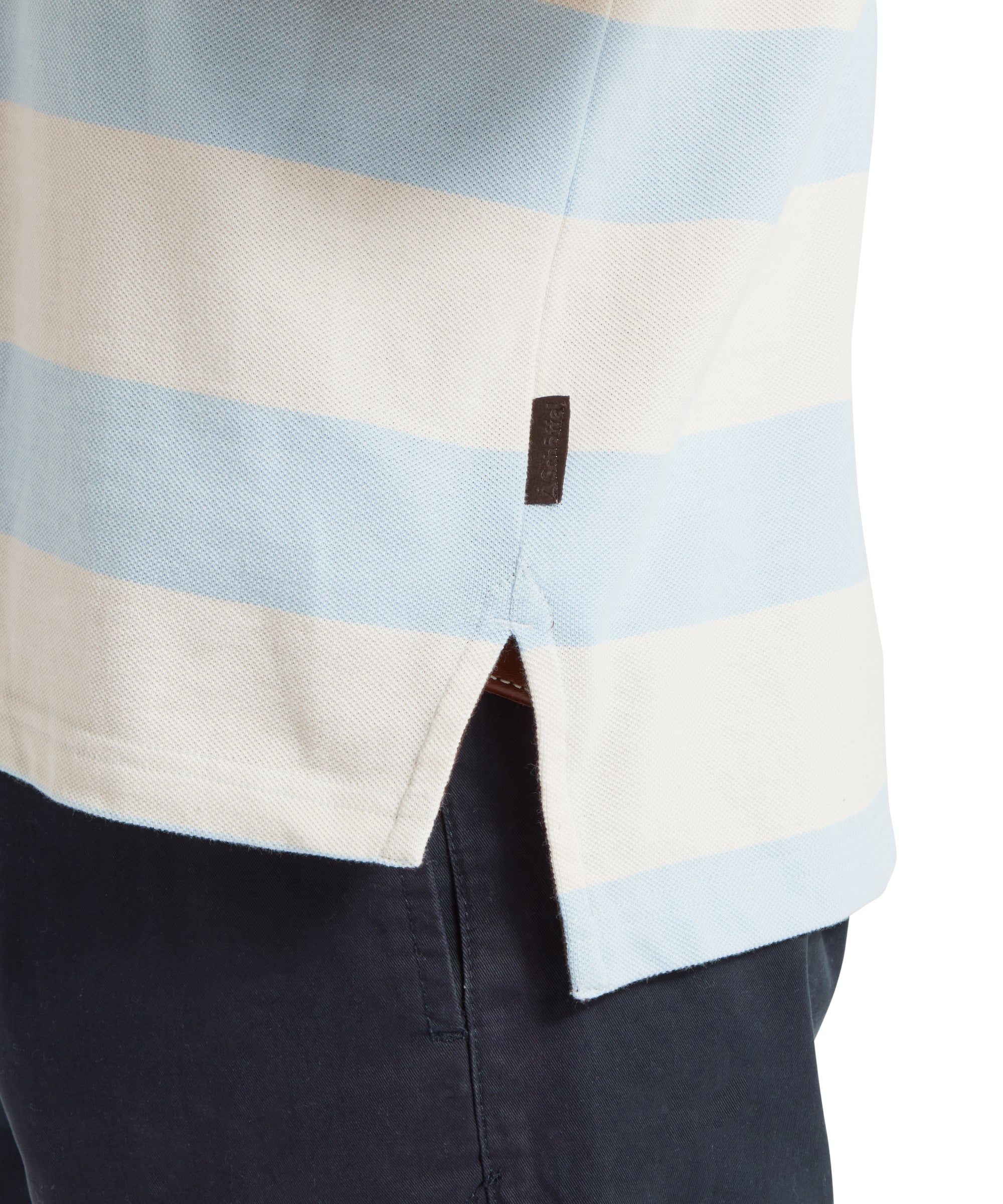 A close up image of a male model wearing a blue and beige striped Schöffel polo shirt. The image highlights the split hem of the polo.