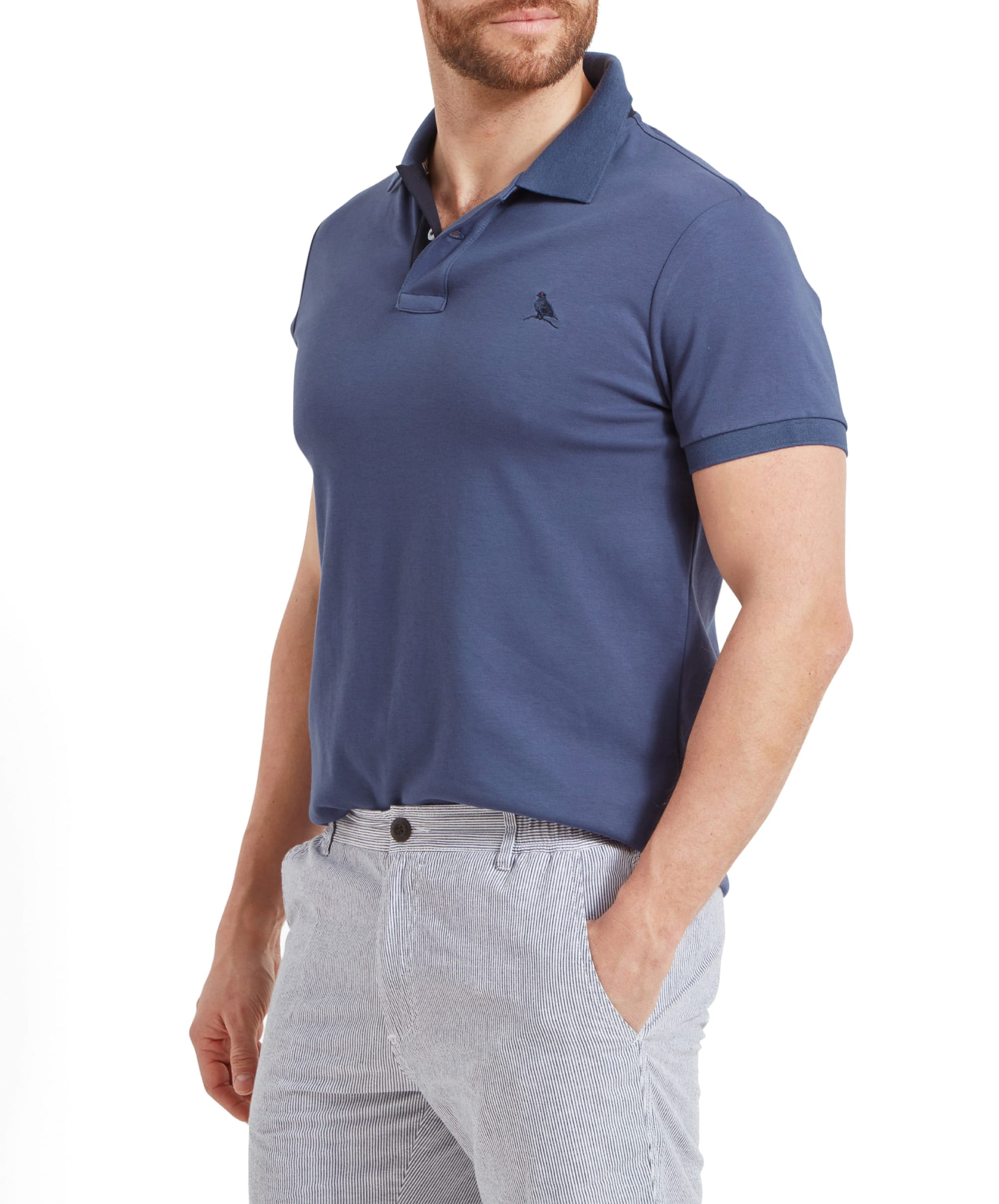 Side profile of the Schöffel St Ives Jersey Polo Shirt for Men in Blue, highlighting the fit and style of the shirt on the model.